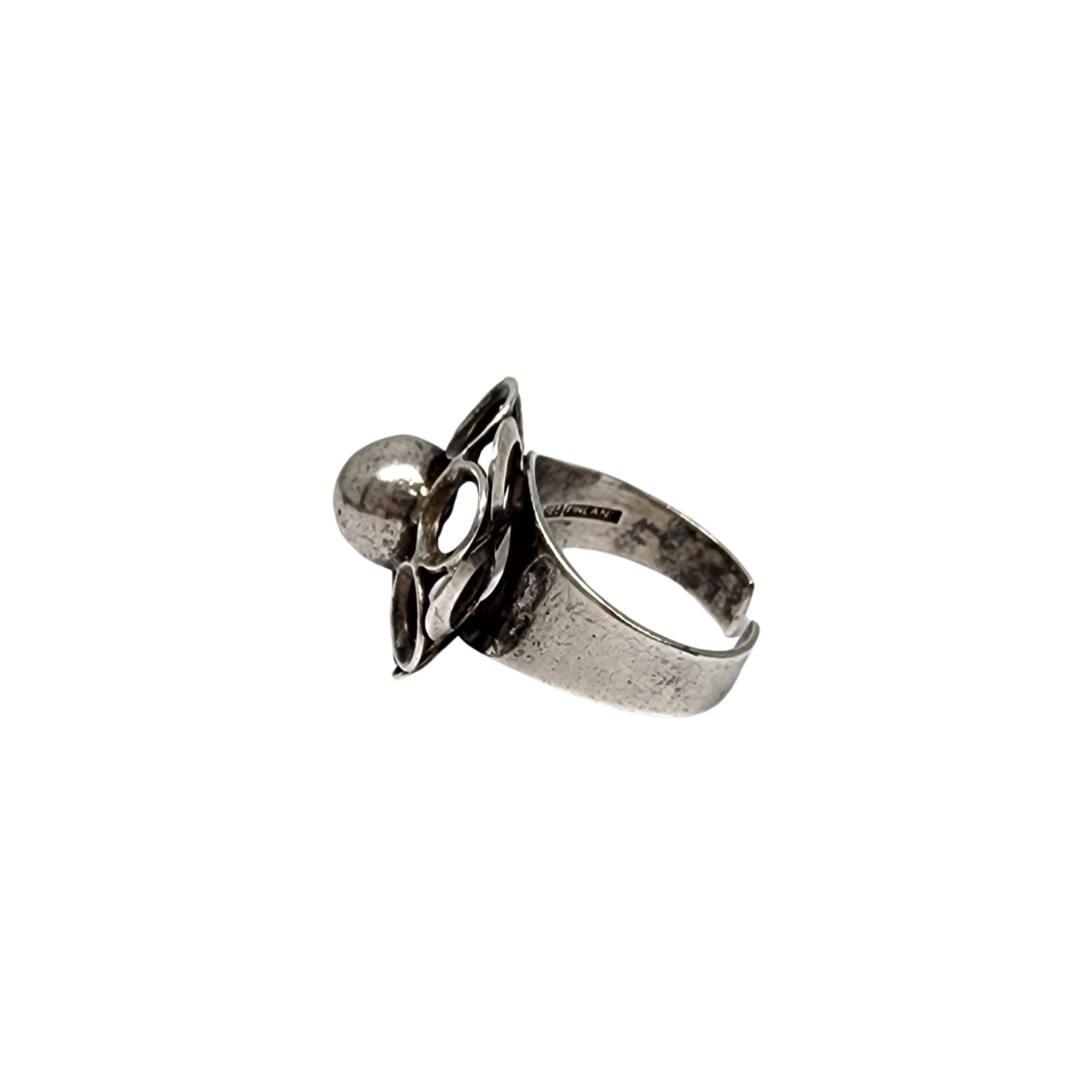 Sterling silver flower ring by Kultaseppa Salovaara of Finland.

Size is adjustable.

Modern design open petal flower with silver bead center, this ring is open at the back for an adjustable fit. Currently fits size 8.

Measures approx 7/8