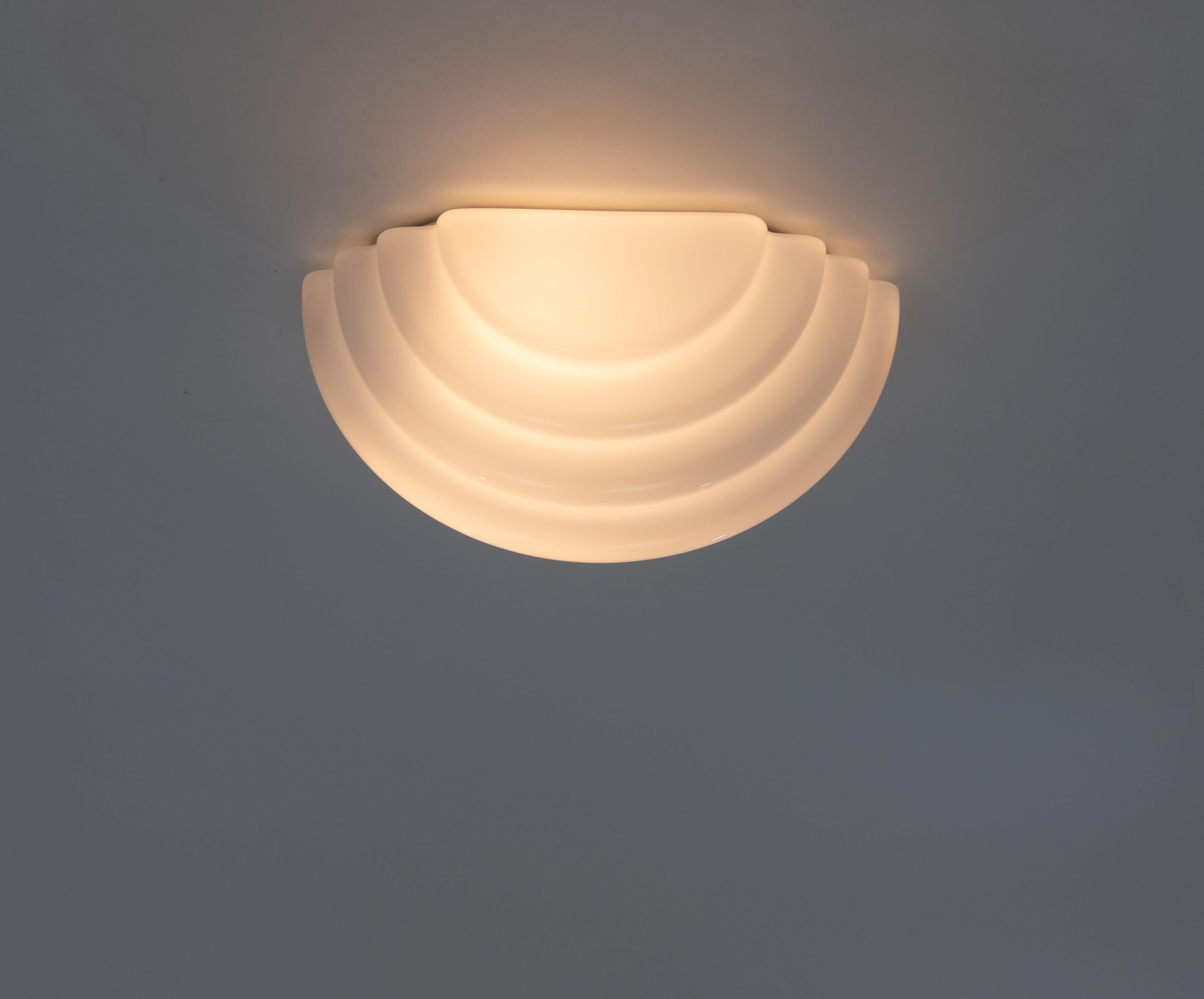 Kumo ceiling or wall lamp designed by Kazuhide Takahama and produced by Sirrah in 1985.

The model consists of an opaline glass shade and a metal suspension base.

Literature: Domus No. 657, Article 'Rassegna Speciale Euroluce', January 1985.