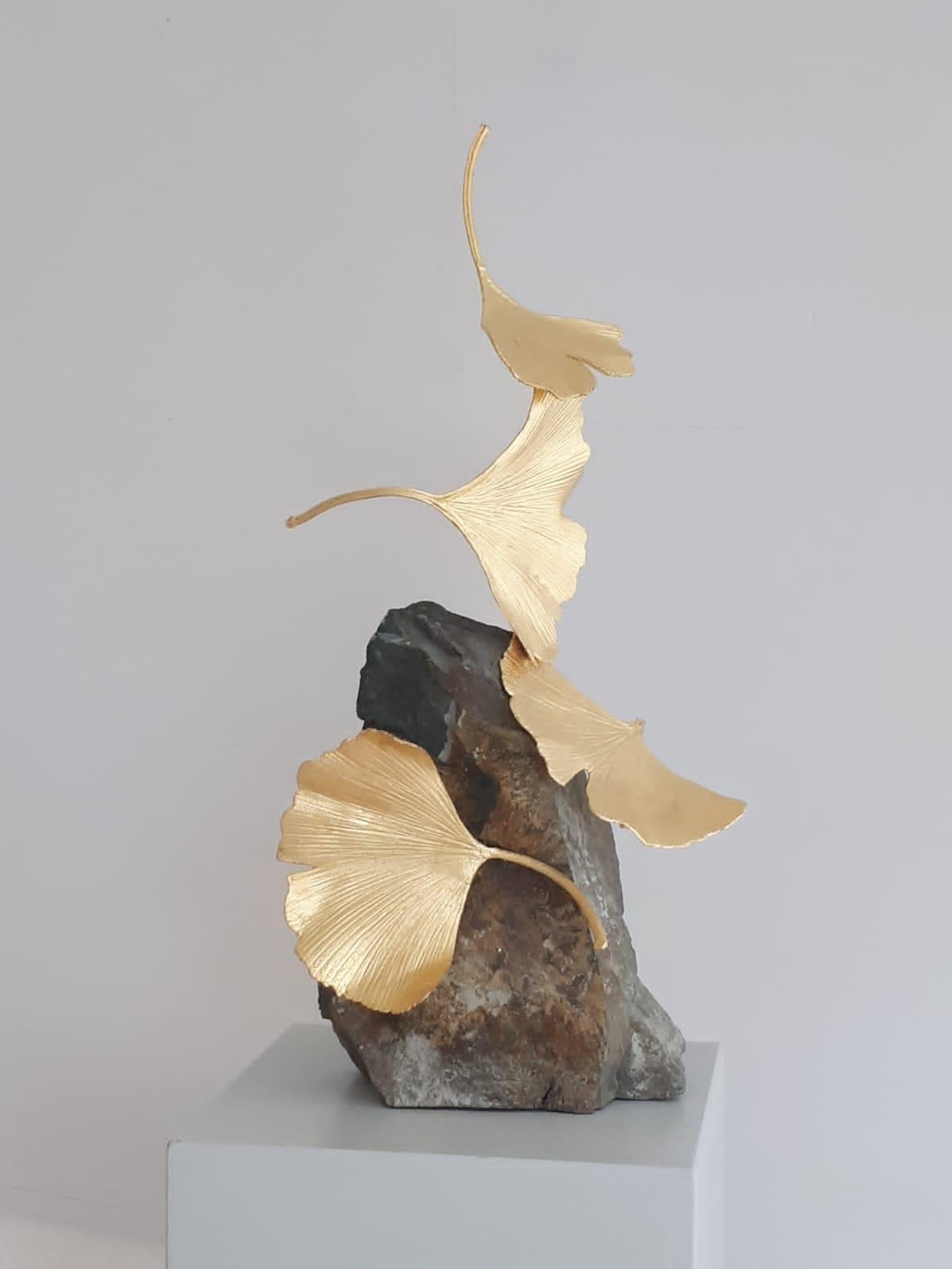 Artist: Kuno Vollet
Title: 4 Leaf Stone Gingko 
Materials: Cast brass, gold leaf, Stone base

This small elegant original brass cast and gold leaf sculpture by German artist Kuno Vollet brings nature and energy into any art collection.
Each leaf is