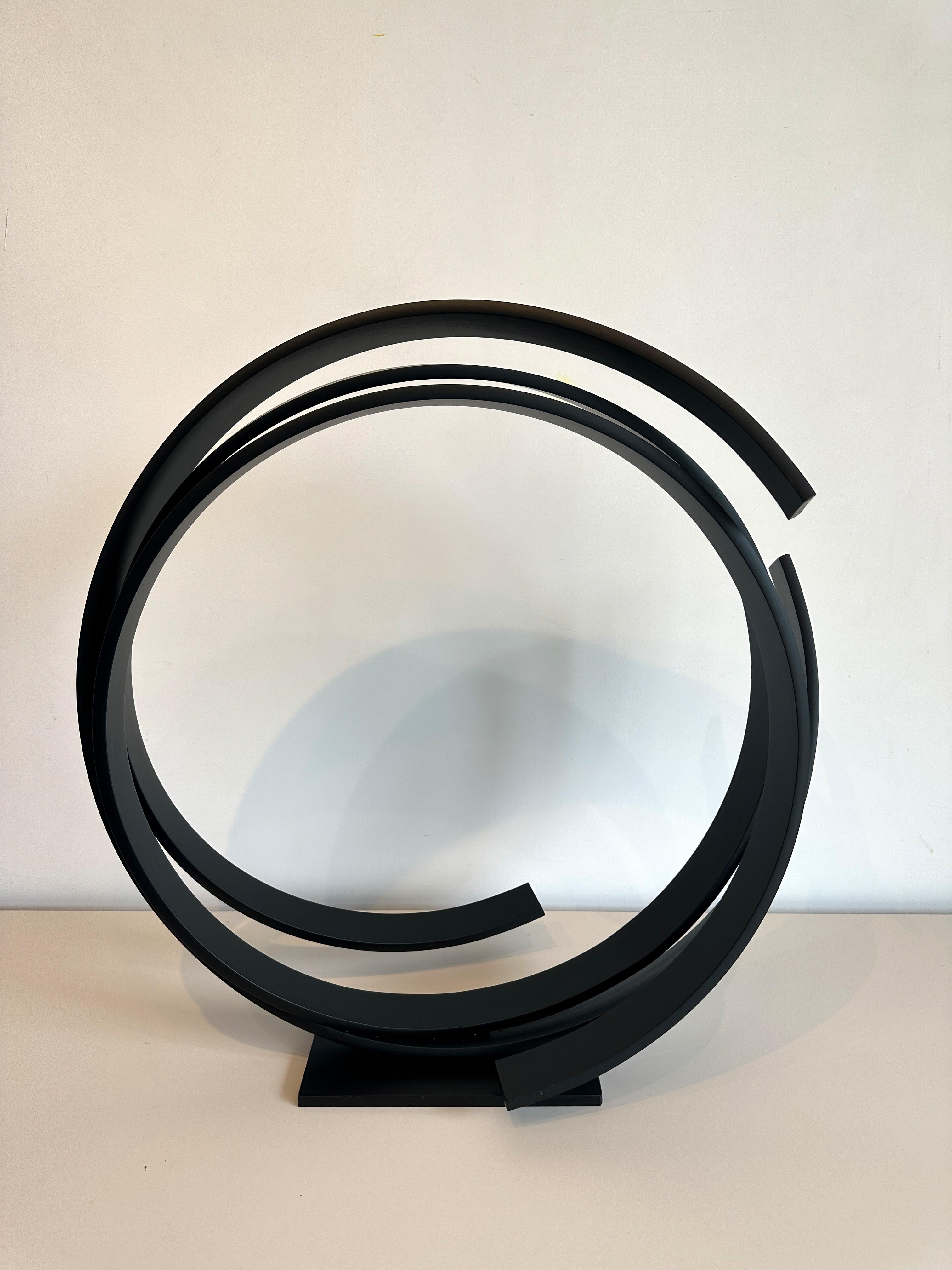A large contemporary black powder coated steel sculpture. Beautiful on the floor or a pedestal. 
A contemporary statement piece full of elegance and movement.
_______________________________________________________________________

Born in 1951 in