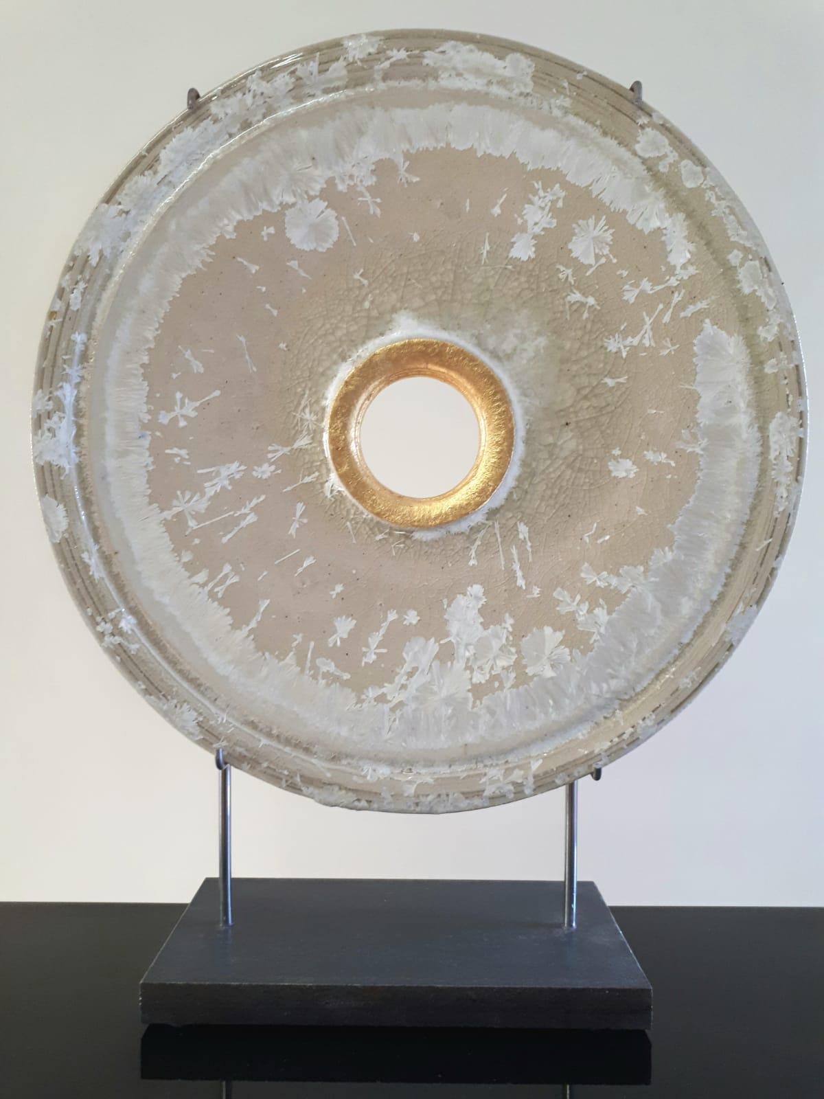 This beautiful, contemporary circular sculpture made from ceramics with crystal glaze and 24k gold leaf stands on an elegant white granite base.
It is a timeless piece full of detail from the burning and glazing process.
Titled on verso.

About the