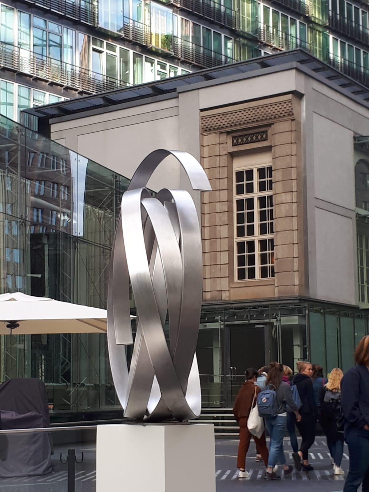 This stunning large aluminum sculpture is a statement piece for any contemporary collection. 
Beautiful for indoor or outdoor installation. 
The reflective property of the silver steel alongside its circular shape make it a timeless and elegant