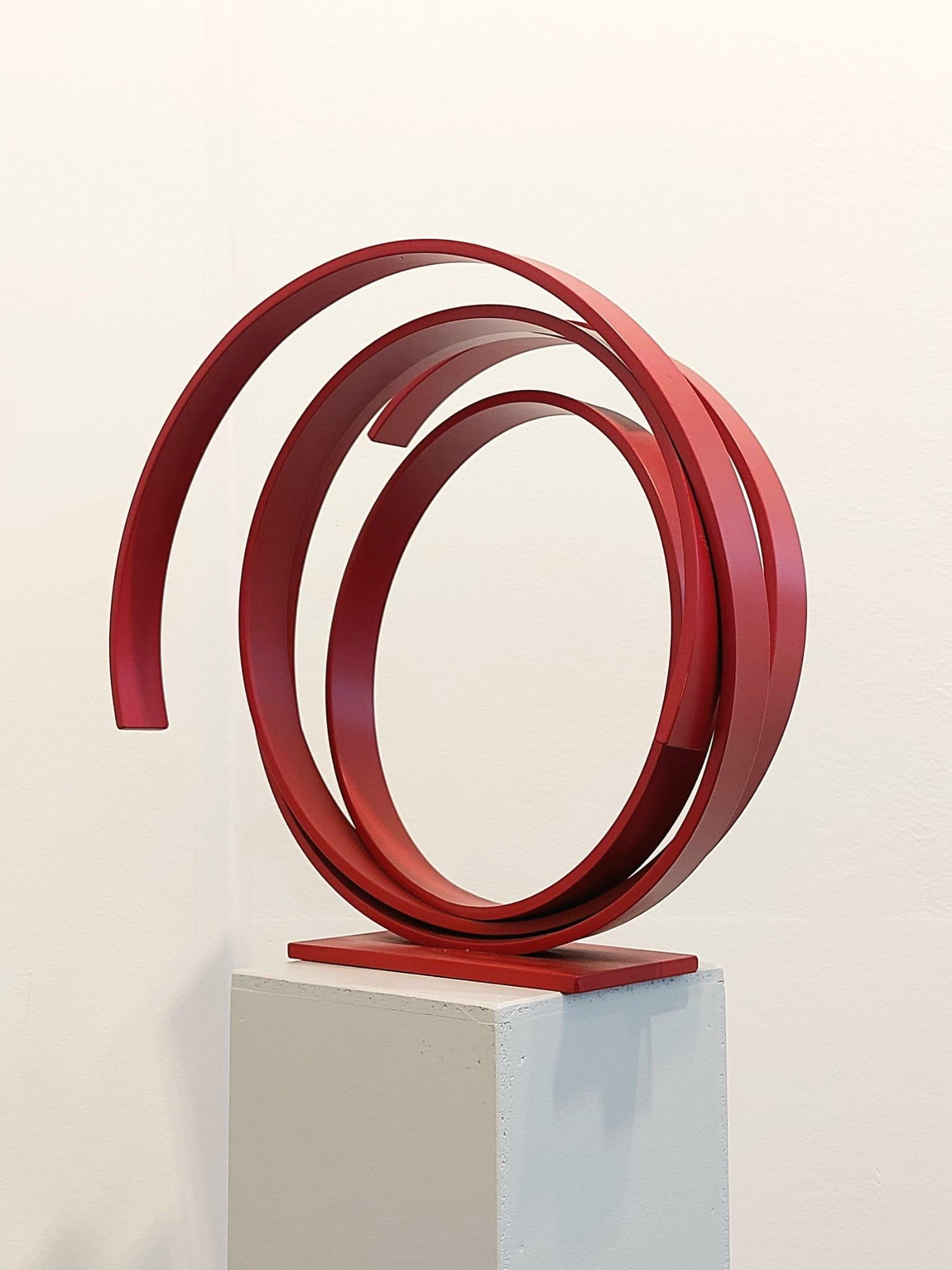 A large contemporary red powder coated steel sculpture. Beautiful on the floor or a pedestal. 
A contemporary statement piece full of elegance and movement.
_______________________________________________________________________

Born in 1951 in