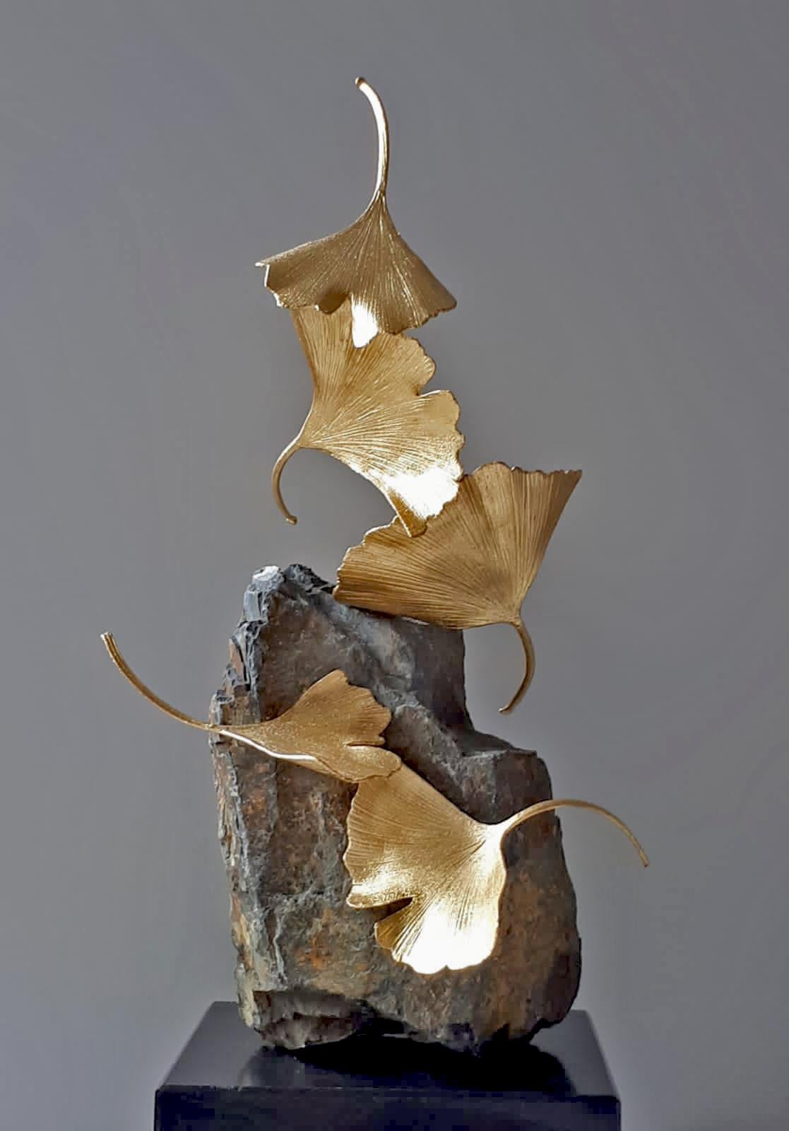 Artist: Kuno Vollet
Title: Stone Gingko 
Materials: Cast brass, gold leaf, Stone base

This small elegant original brass cast and gold leaf sculpture by German artist Kuno Vollet brings nature and energy into any art collection.
Each leaf is