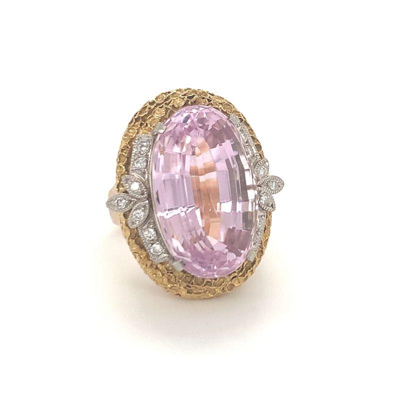 One pink kunzite and diamond 18K yellow gold and platinum ring featuring one oval brilliant cut kunzite weighing 25.50 ct. Enhanced by 14 round brilliant cut diamonds totaling 0.25 ct. and with a textured sponge gold finish. Circa 1960s.

Vibrant,