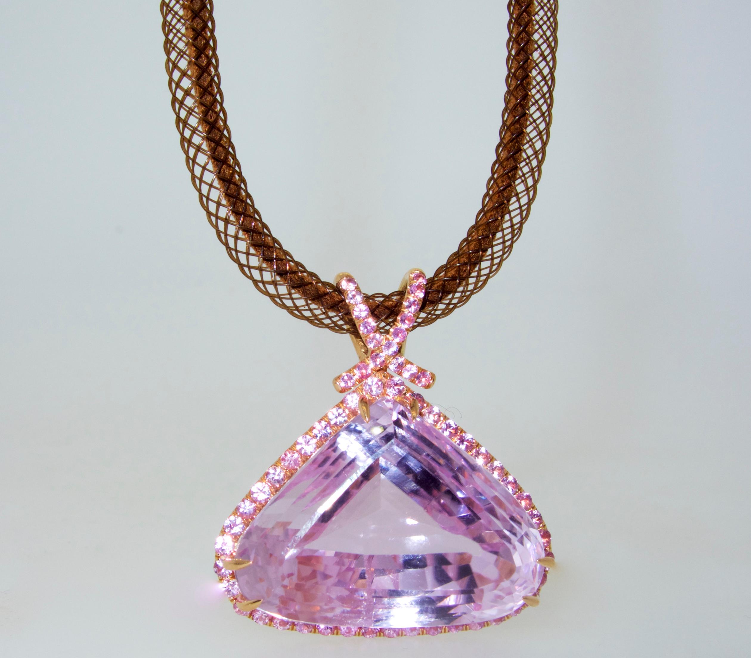 Kunzite, natural and  of very fine quality - as evident of the bright vivid and  strong pink color (with a very slight undertone of lavender).    This center stone weighs approximately 55 cts . and has a fancy cut, not windowed, and not a diluted