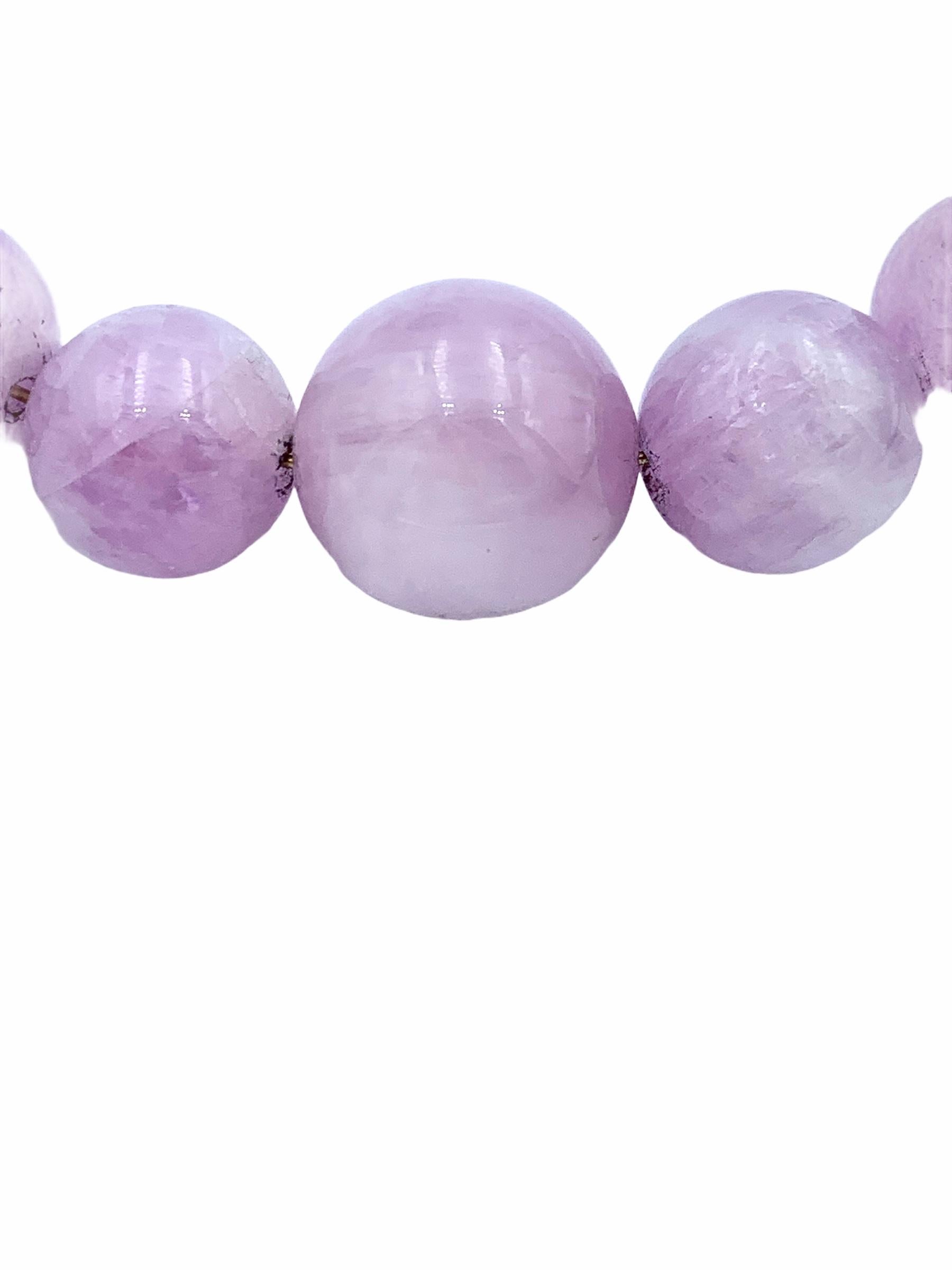 Hand made using 14 carat Yellow Gold, the suspended Kunzite beads are threaded together with a solid gold wire and graduated onto a delicate 1.3 mm cable chain. The subtly lilac and pink hues have a centre bead which measures 12 mm in size, 10mm the