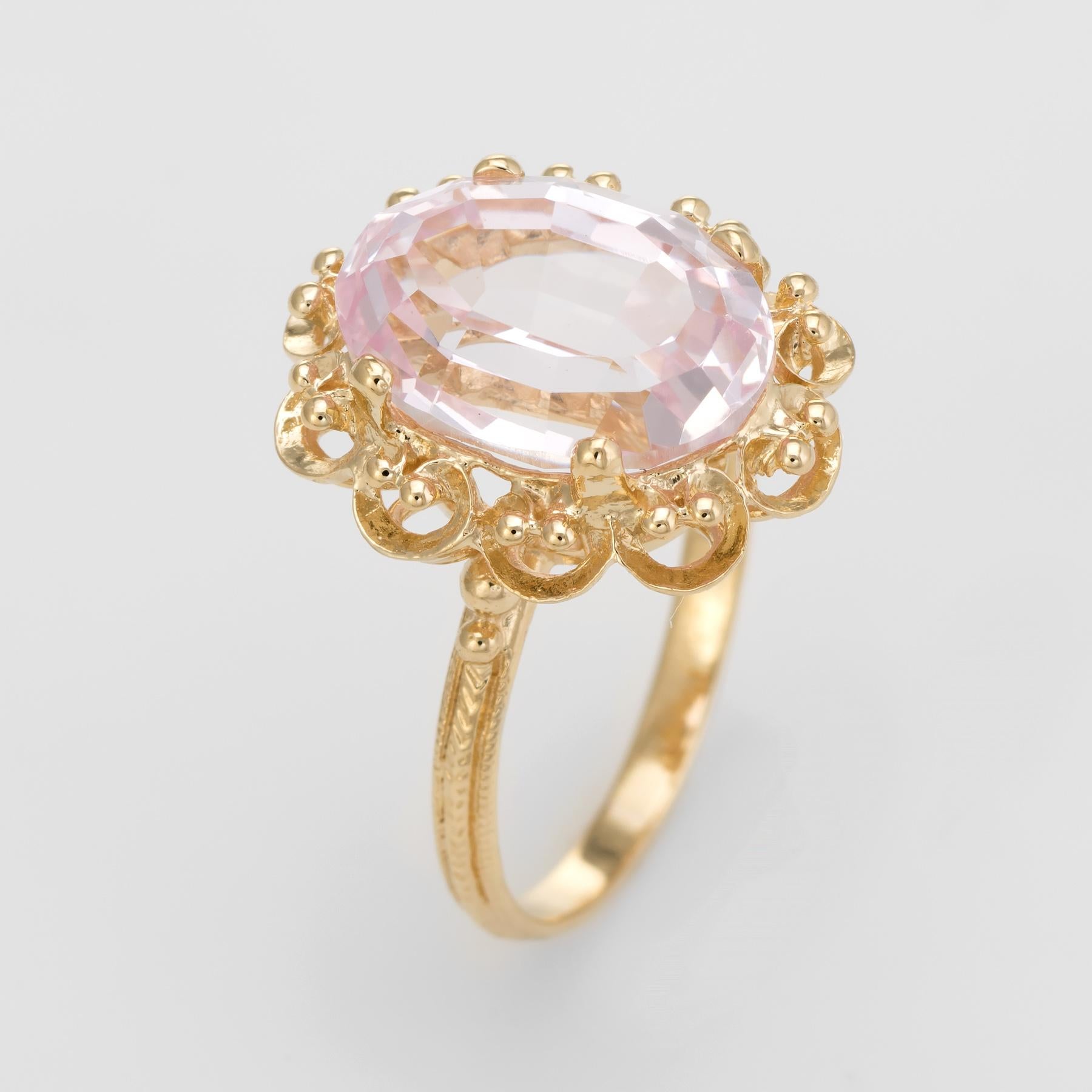 Finely detailed vintage cocktail ring, crafted in 18 karat yellow gold. 

Centrally mounted oval faceted kunzite measures 14mm x 10mm (estimated at 8 carats). The kunzite is in excellent condition and free of cracks or chips.   

The ring is in