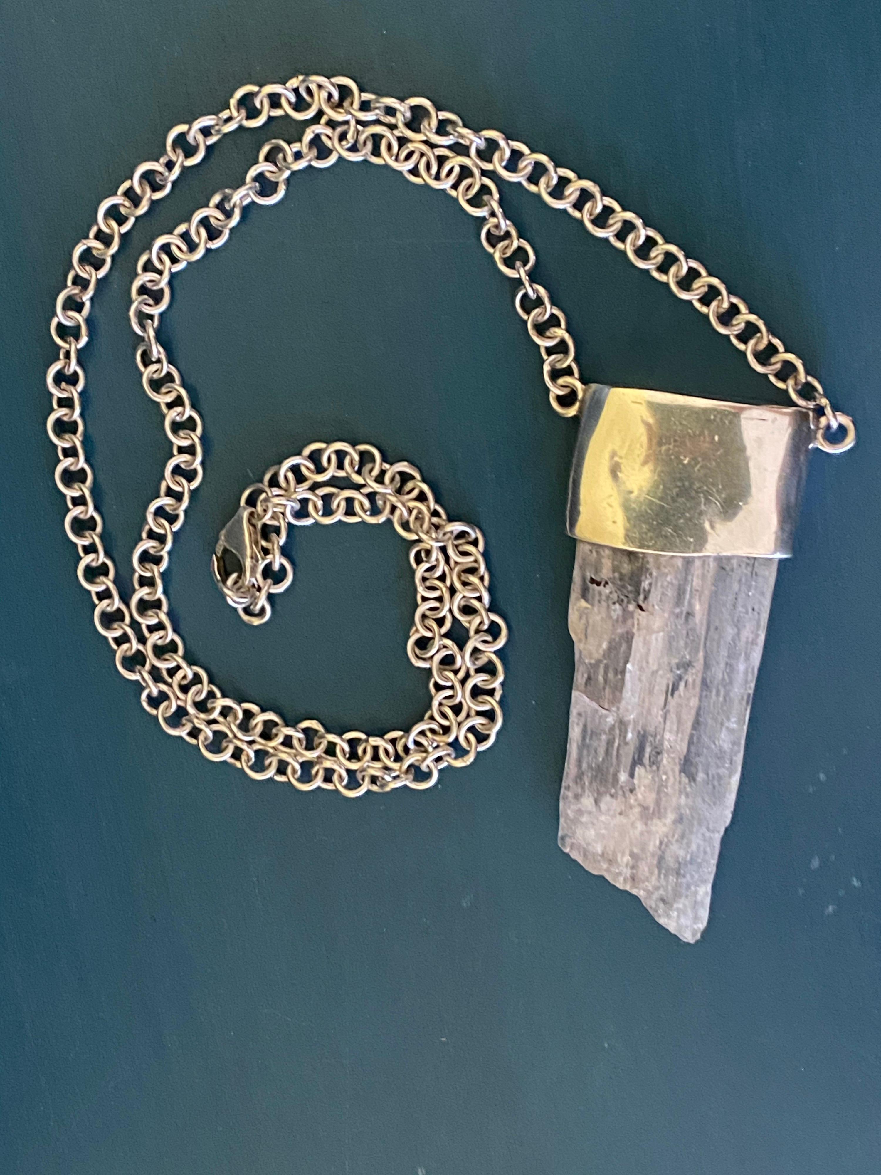 Chunky Uncut large Kunzite Crystal set in a top bezel of Sterling Silver and a Rolo style chain with a generous Lobster Claw Clasp. Bohemian Chic Fashion styled necklace that will match any outfit. Measures 14 inches in length. 