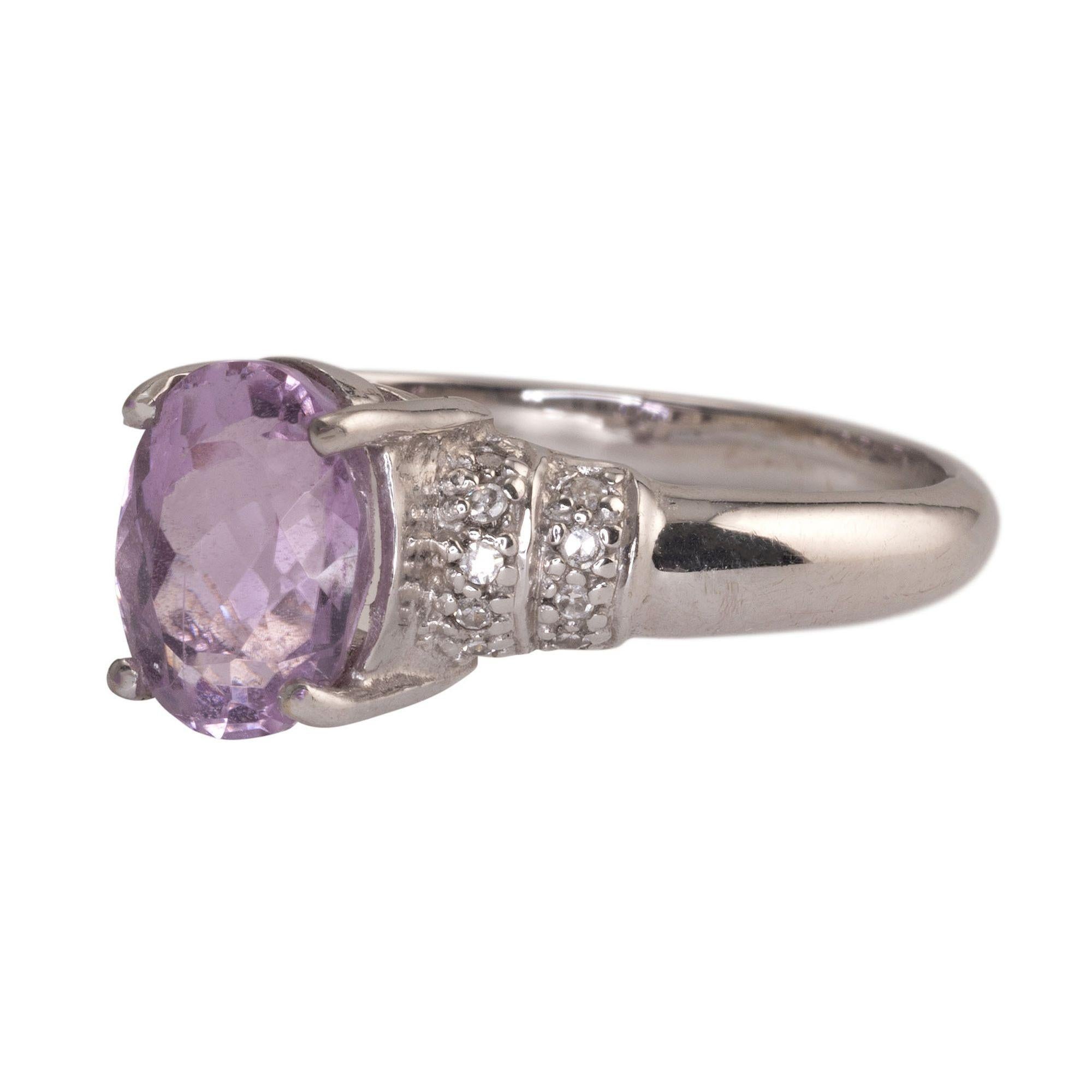 Estate kunzite & diamond 18K white gold ring. This 18 karat white gold ring features a 1.89 carat oval kunzite center stone with .066 carat total weight of accent diamonds. The kunzite ring is a size 6.75. [RHAW 39]

*Resizing available for