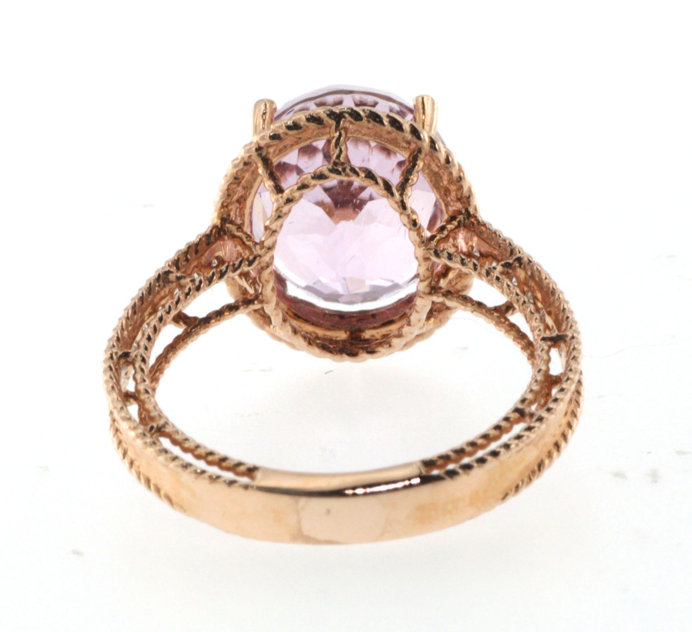 This ring features a 6.40 carats kunzite, assented with 0.14 carat of white round diamonds on the shoulder. Ring is set in 14 karat rose gold. The gold is made in a twisted-bead finishing. 
US 6.5
Resizing is available
Kunite 6.40 carats
White Round