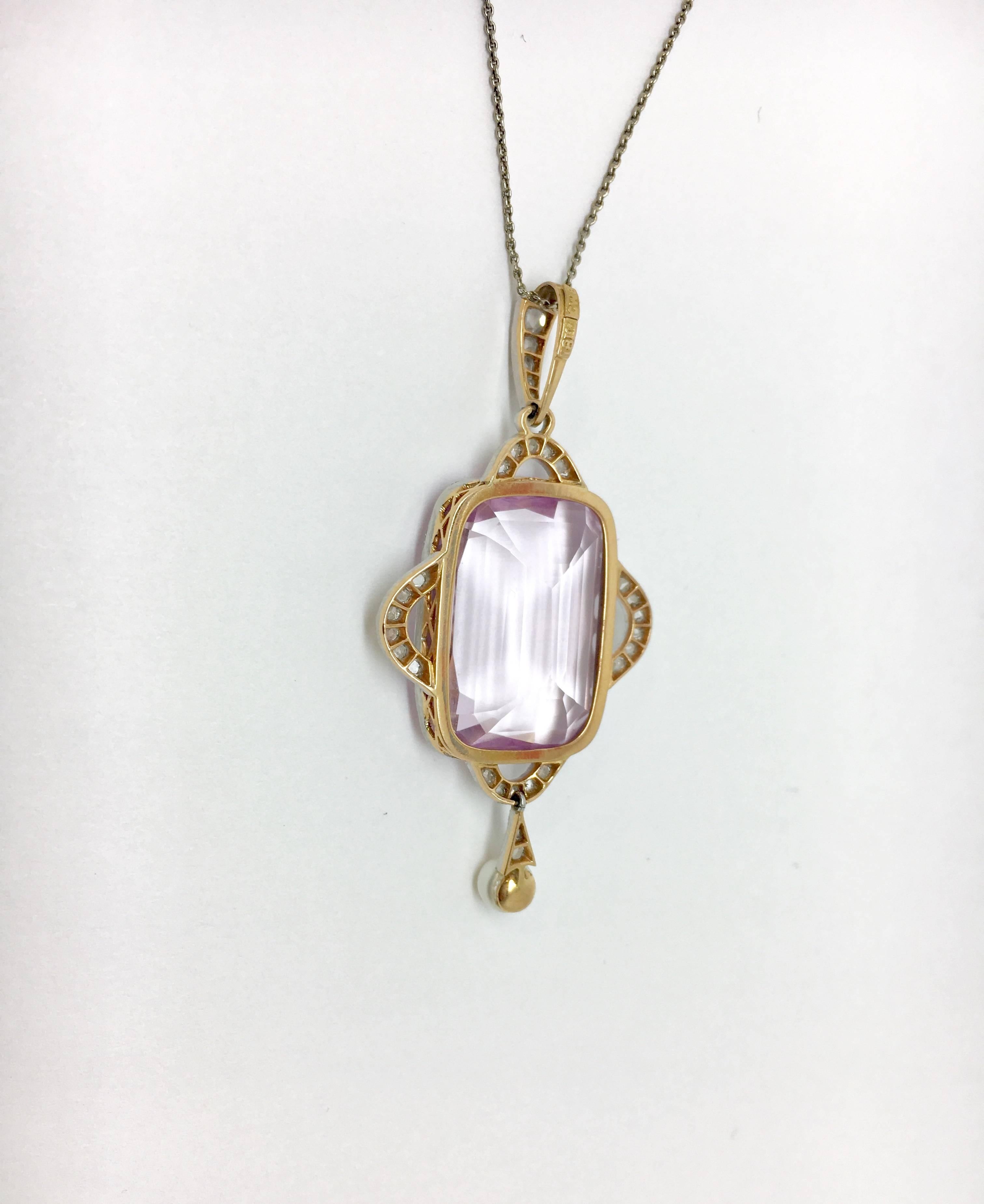 One estate spodumene kunzite pendant. Set in 18kt gold & platinum. Rose cut diamonds 0.25 t.w SI2-I2 / H-J.  The chain is currently 15 inches in length. This kunzite is approximately 23 carats. It is light pink to violetish purple variety of the