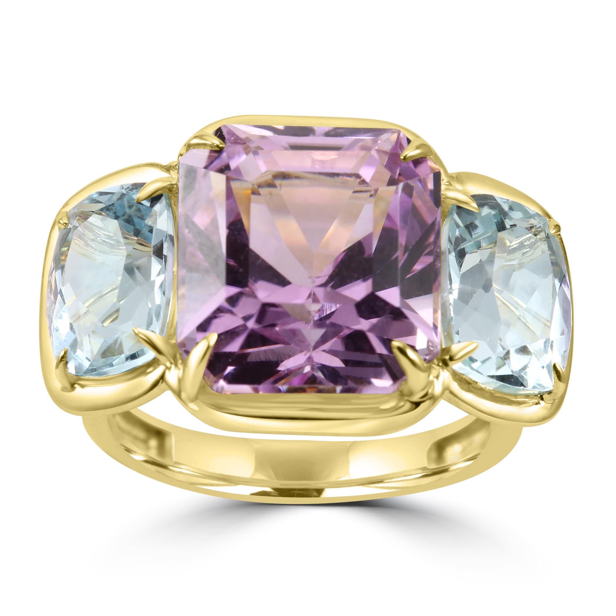 At the heart of this ring is a magnificent Kunzite Emerald Cut Center, boasting an impressive 11.45 carats. The soft purplish color of the Kunzite adds a touch of romance and femininity to the design, making it a standout feature.

Flanking the