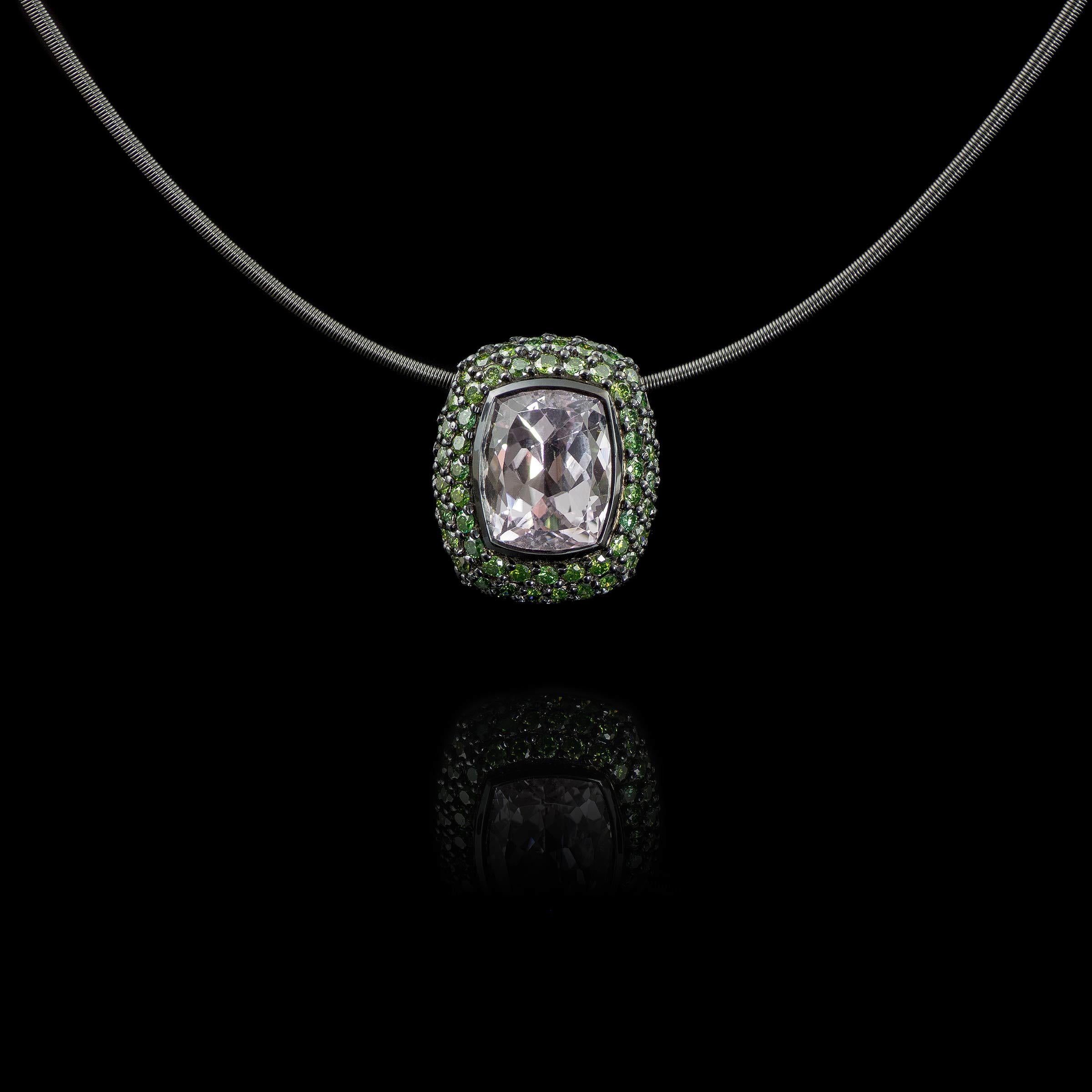 Pastel pink kunzite pendant framed by green diamonds. 