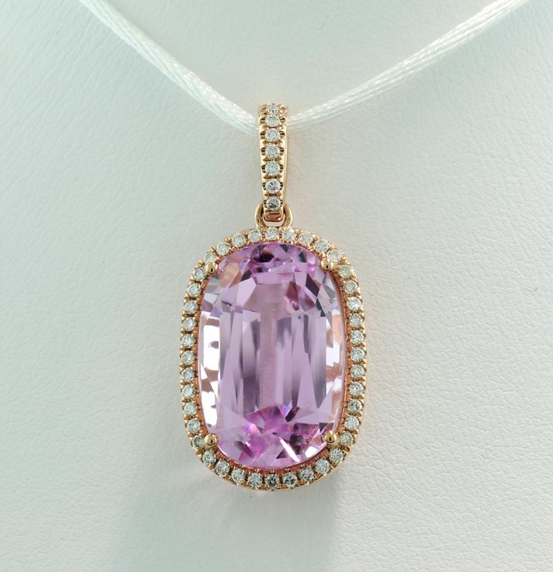 A stunning pendant, featuring a kunzite gemstone weighing approximately 24.11 carats, in a vibrant mauve color—an eye-clean quality with a beautiful luster. The kunzite is cut in an oval cushion shape with a mixed cut (rose cut / step cut), set in