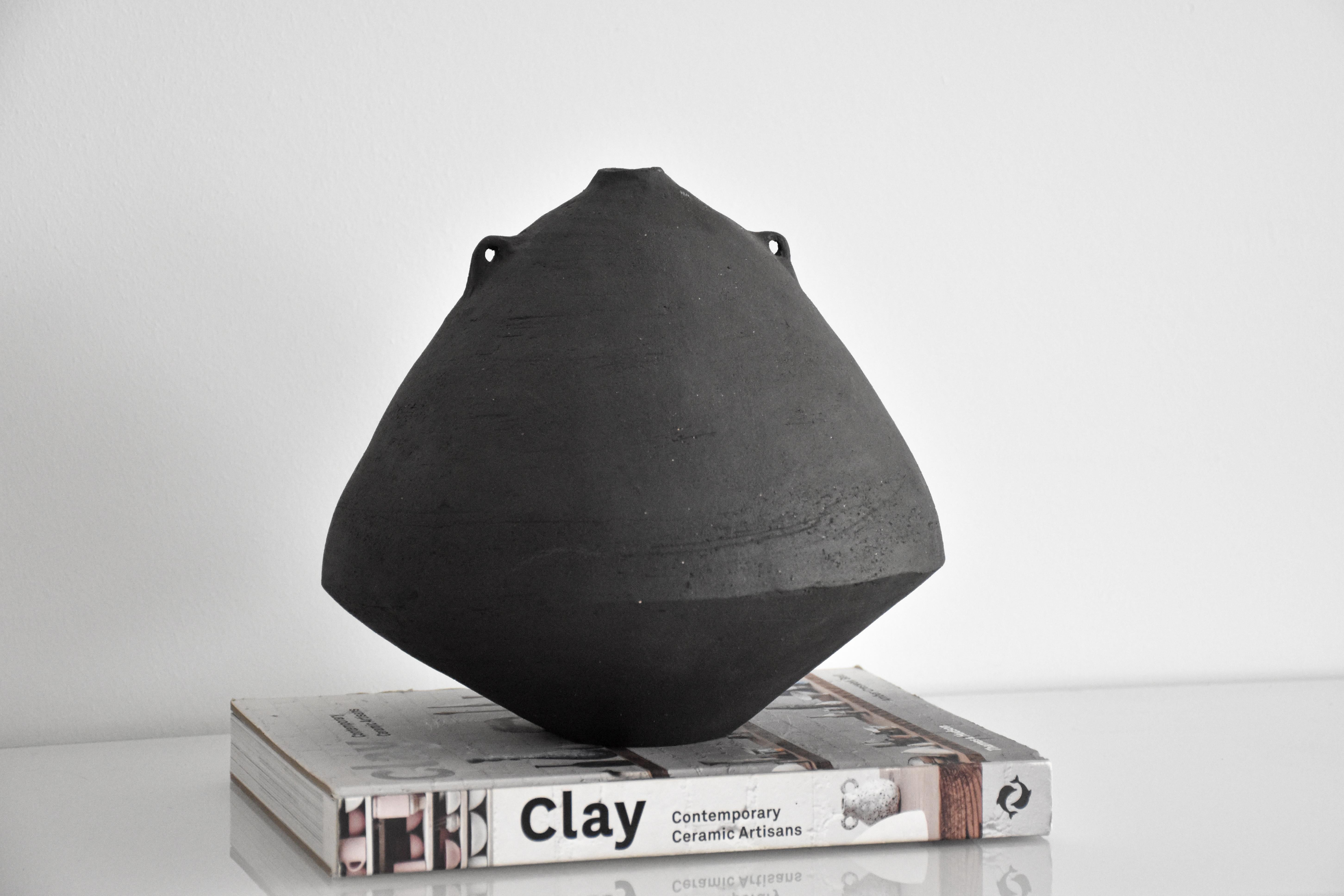 “Küp #S1” is a sculptural vase which made with hand building technique with stoneware clay. It has a raw texture and unglazed surface. There are three different models and two different colors of Küp Collection, which works well alone or together as