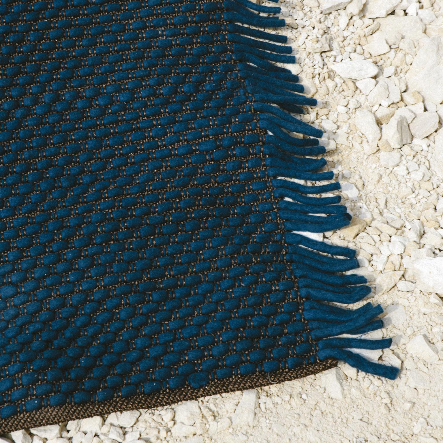 Handwoven rug made in polyester and felt. The felt cords appear and disappear from the polyester warp and find their identity in the straight, compact fringes on the side.

Standard size: 6.6' x 9.9' (200 x 300 cm)
Also available in 5.6' x 7.9' (