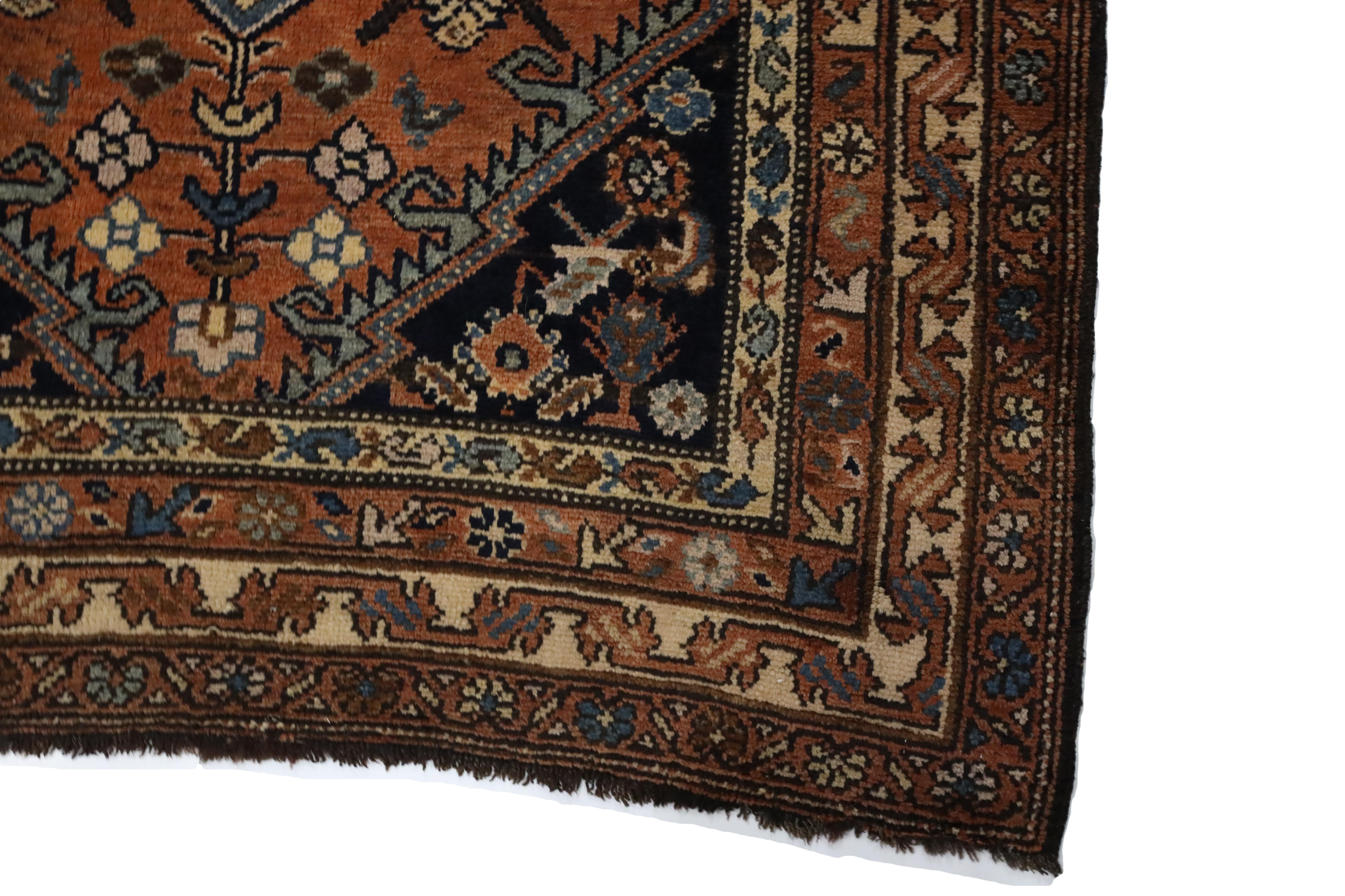 can you write me a rug description, for a kurd rug. it has a light red background with a light blue medallion. there are some floral and geometric motifs as well as some bird motifs in the open space around the medallion with additional colors like