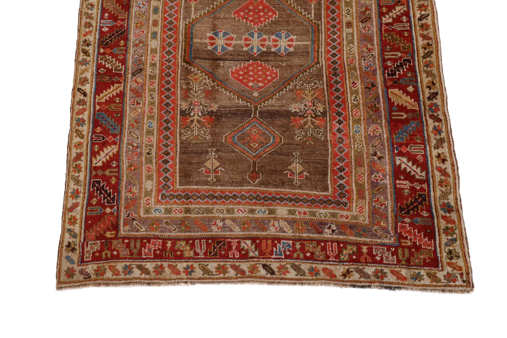 The Kurd-Bidjar rug is an extraordinary masterpiece that showcases a unique and captivating design, carefully woven with meticulous artistry. With a rich brown background, this rug allows the earthy hues to take center stage, creating a warm and