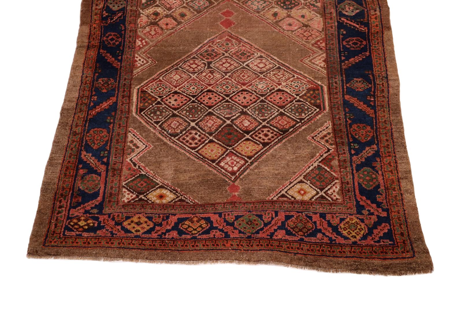 The Kurdish Bidjar rug exudes a timeless and unparalleled elegance, boasting a rich and inviting brown background that forms the perfect canvas for an intricate and distinctive medallion design. This exceptional piece of craftsmanship is a true