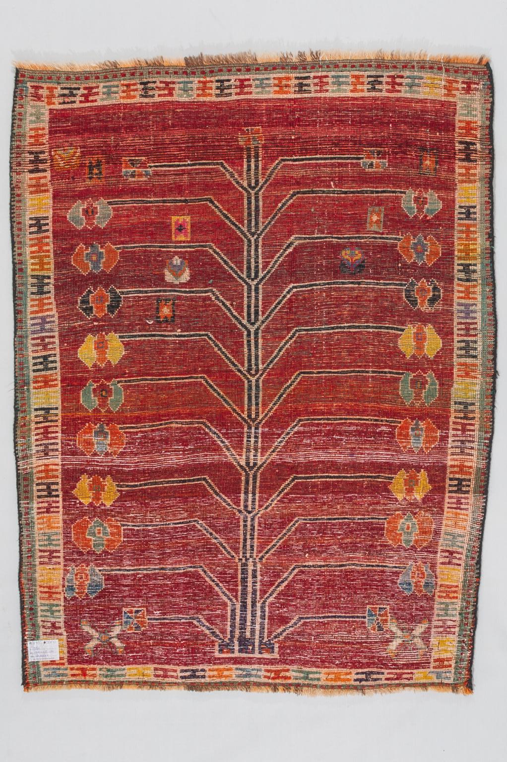 This carpet is a true typical nomadic product from the Kurdish mountains.
A pomegranate tree, a symbol of fertility, occupies the whole field.
It was probably a gift for the newlyweds because the pomegranate is a symbol of fertility.  Very sturdy,