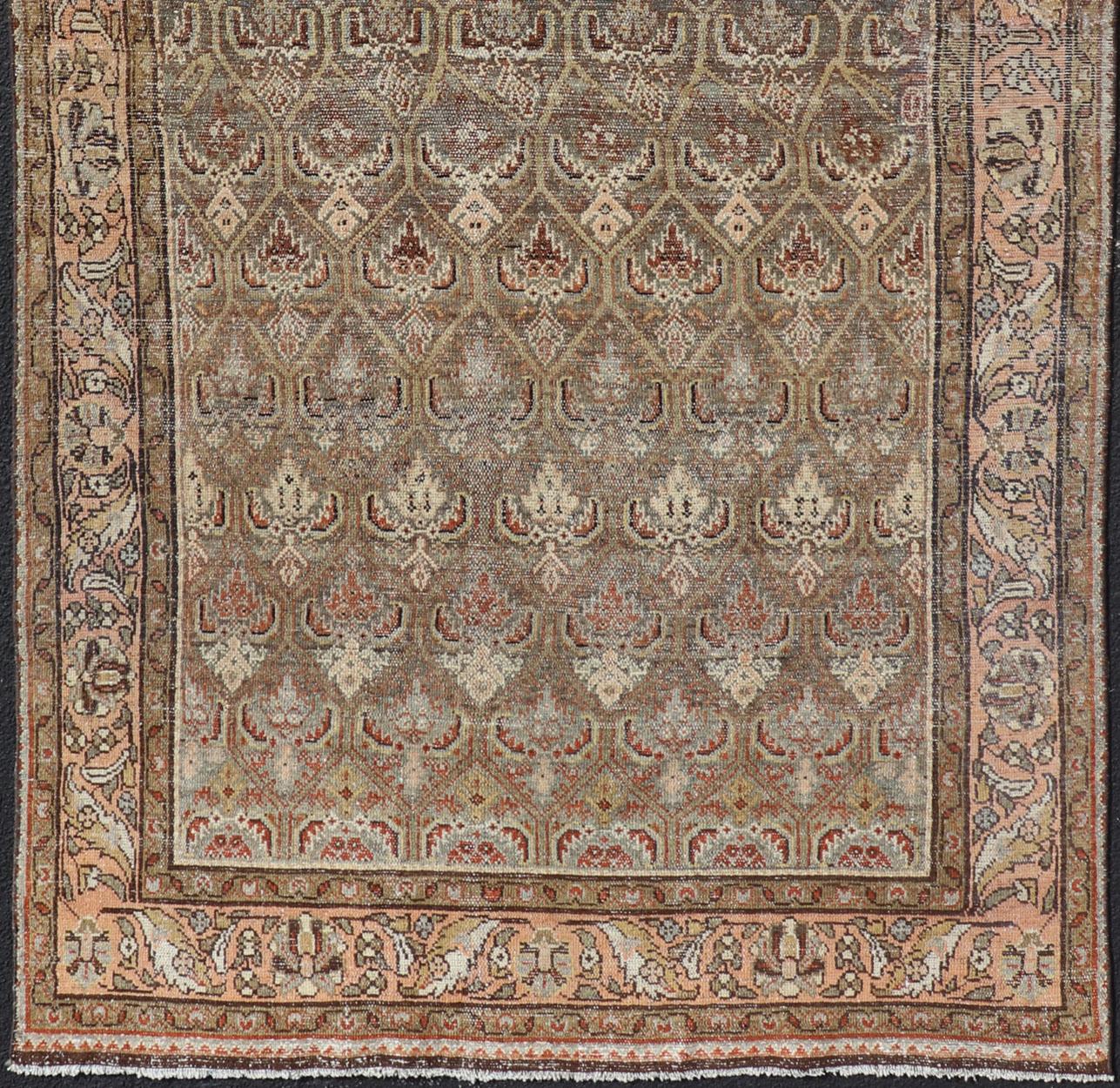 Kurdish antique gallery runner with all-over tribal design in brown's and pink. Keivan Woven Arts / rug EMB-9609-P13863, country of origin / type: Iran / Kurdish, circa 1920.
This Kurdish antique gallery runner has held timeless charm with a