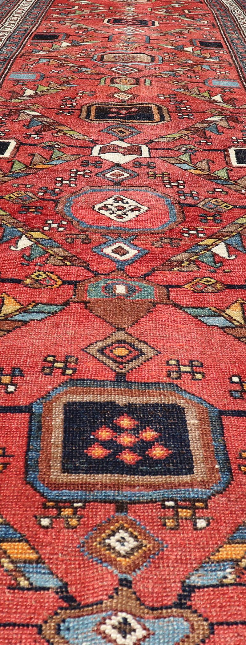 Tribal Kurdish Antique Runner in Vibrant Red Background and Multi-tiered Border For Sale