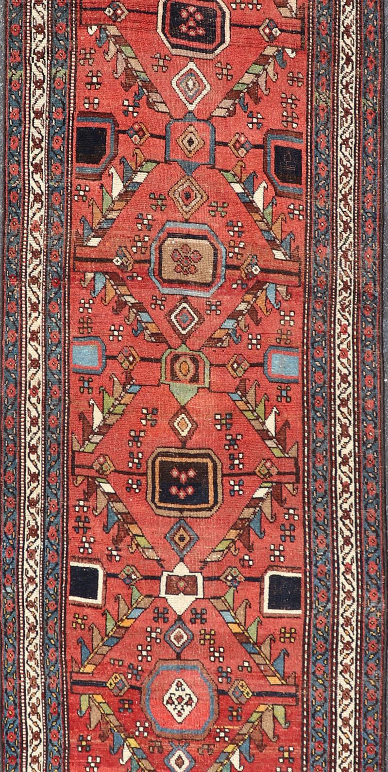 Wool Kurdish Antique Runner in Vibrant Red Background and Multi-tiered Border For Sale