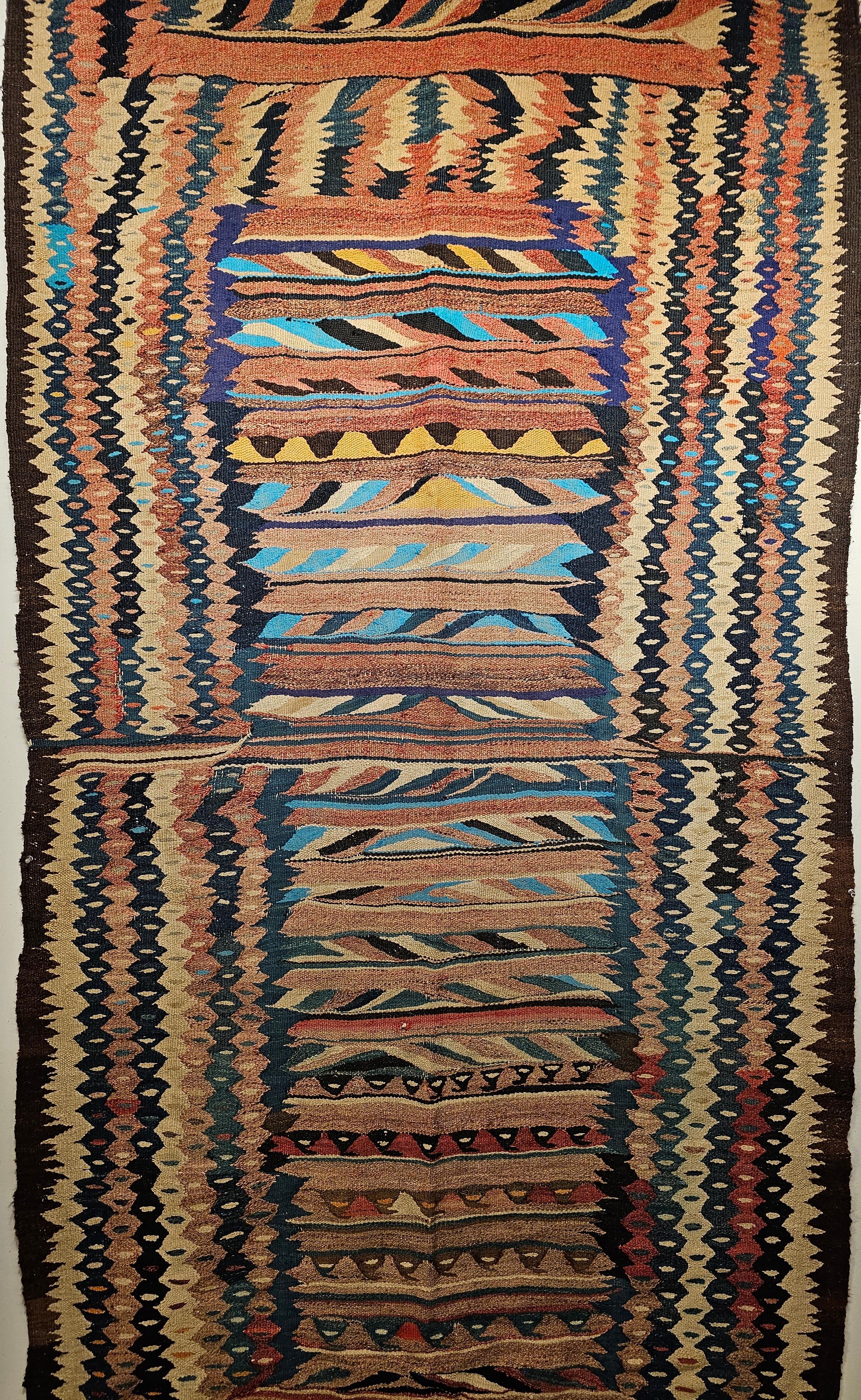 Vintage flat-woven Kurdish kilim with one of the most beautiful and “ultra-modern” designs in brilliant colors of turquoise, green, yellow, ivory, red, and brown from the early 1900s NW Persia.  It is difficult to imagine how the creators of such a