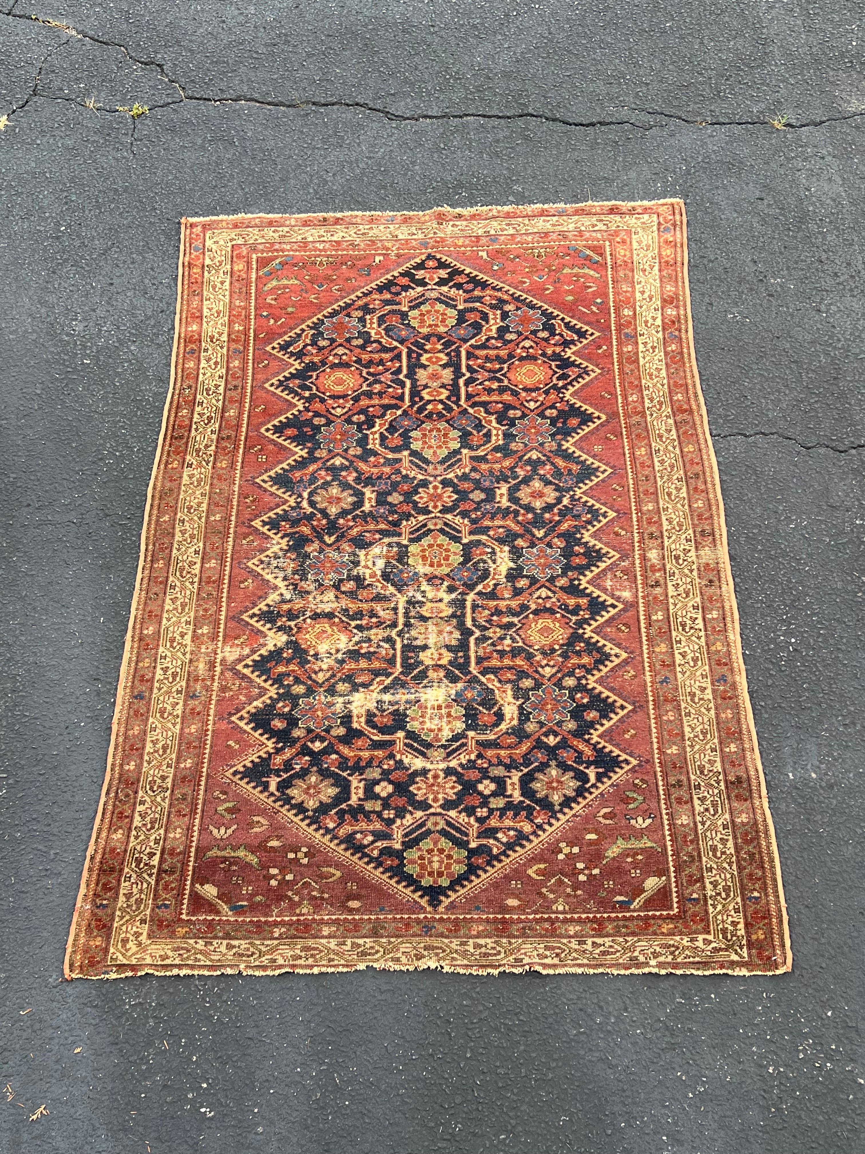 Kurdish Hamadan Tribal Rug .Most likely hand woven in Northern Iraq. We believe the binding is machine . Approximately 85 years old circa 1930-1939. . 4ft 2 inches by 6 ft 2 inches in dimensions. Wear to central medallion. Low pile. Overall colors