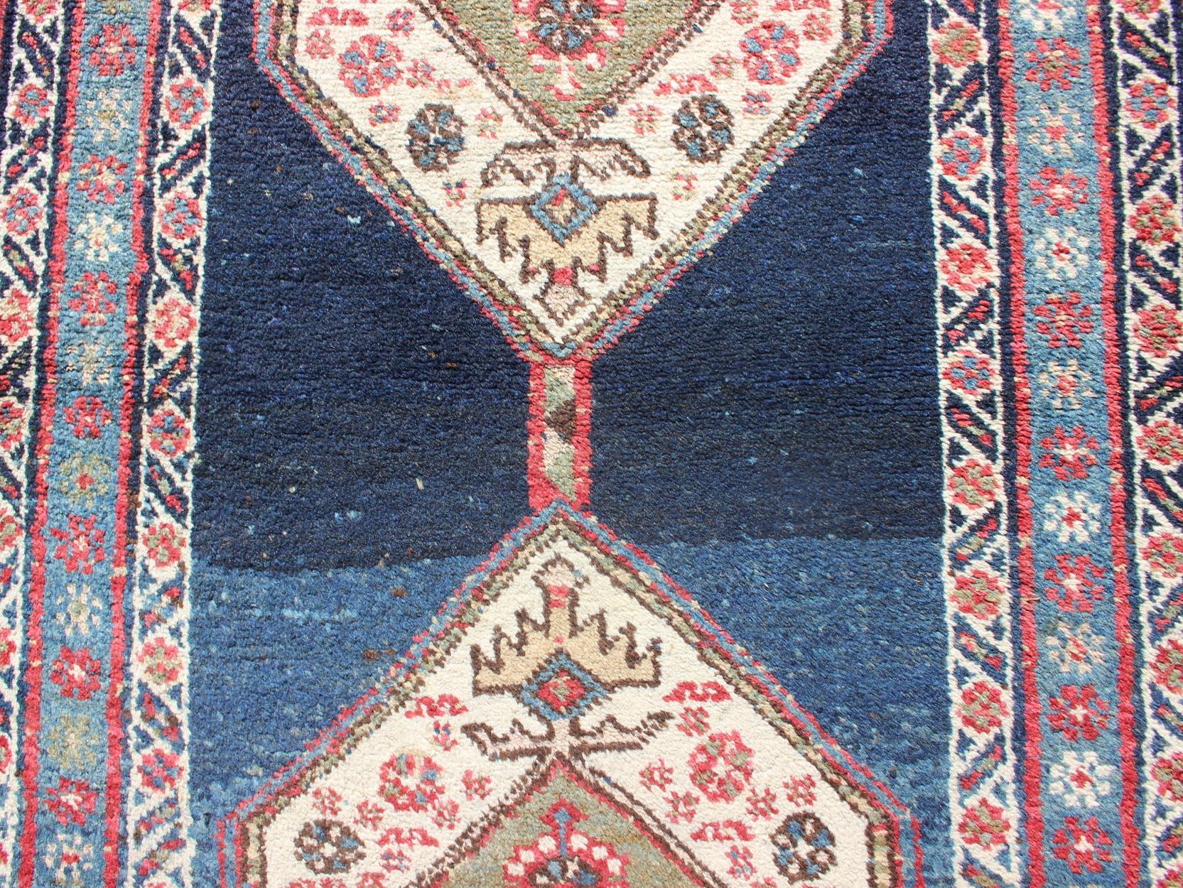 Early 20th Century Kurdish Rug with Blue Background and Two Large Tribal Motifs Runner