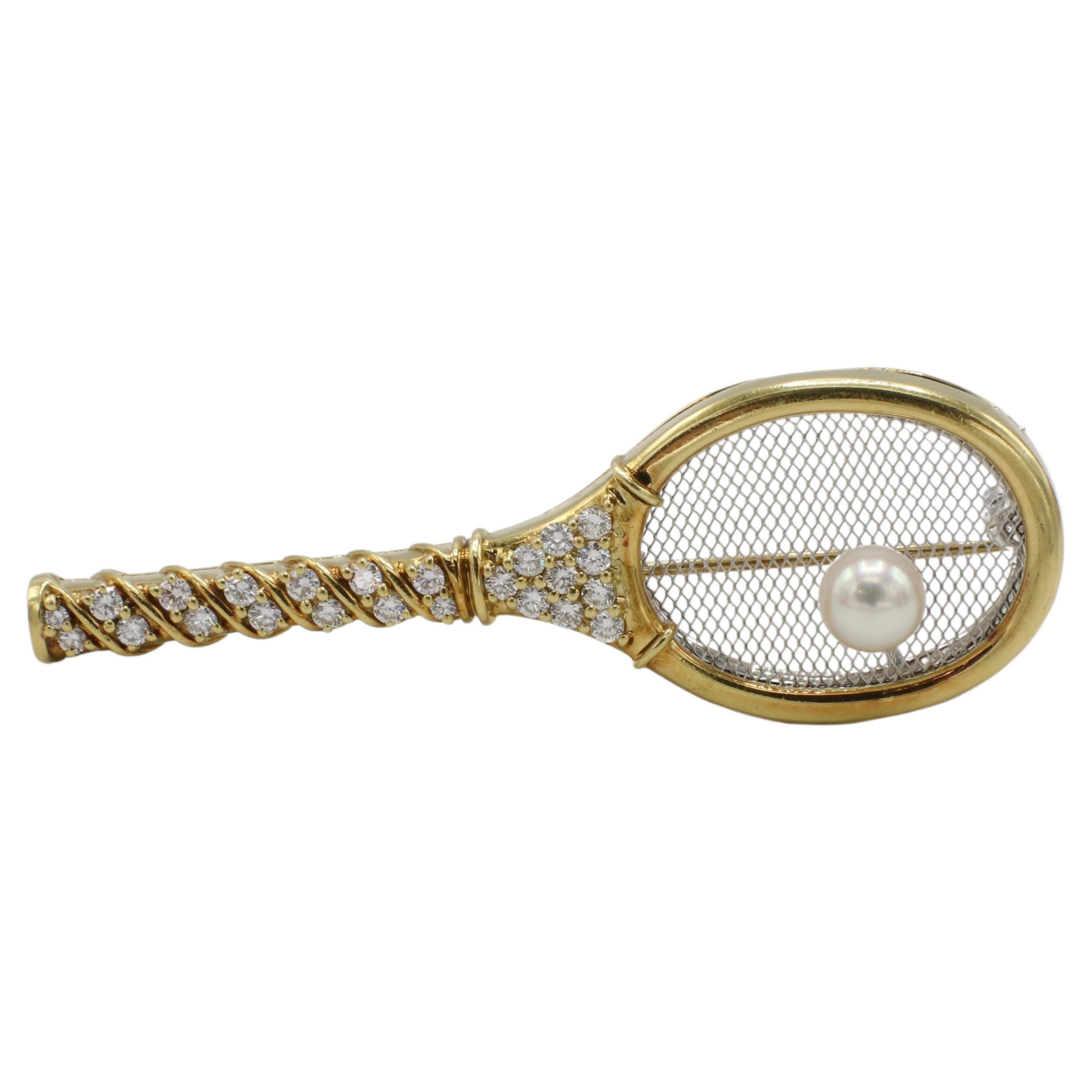 Kurt Gaum 18 Karat Yellow Gold Natural Diamond & Pearl Tennis Racket Pin
Metal: 18k gold and platinum 
Weight: 15.81 grams
Diamonds: Approx. .75 CTW round natural diamonds F-G VS
Dimensions: 62 x 21mm
Pearl: 6.5mm
