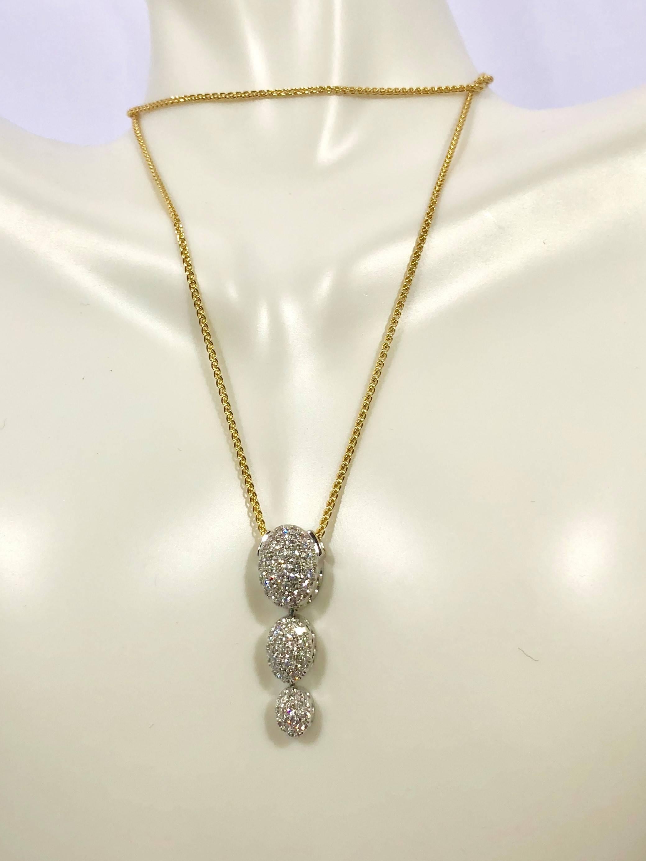 18 Karat white gold diamond pendant by Kurt Gutman, 48- full cut round diamonds = .52 carat total weight, average color G-H, average clarity VS2-SI1, approx. one inch long, weighing 4.5grams/2.9dwt., insurance appraisal provided upon purchase.