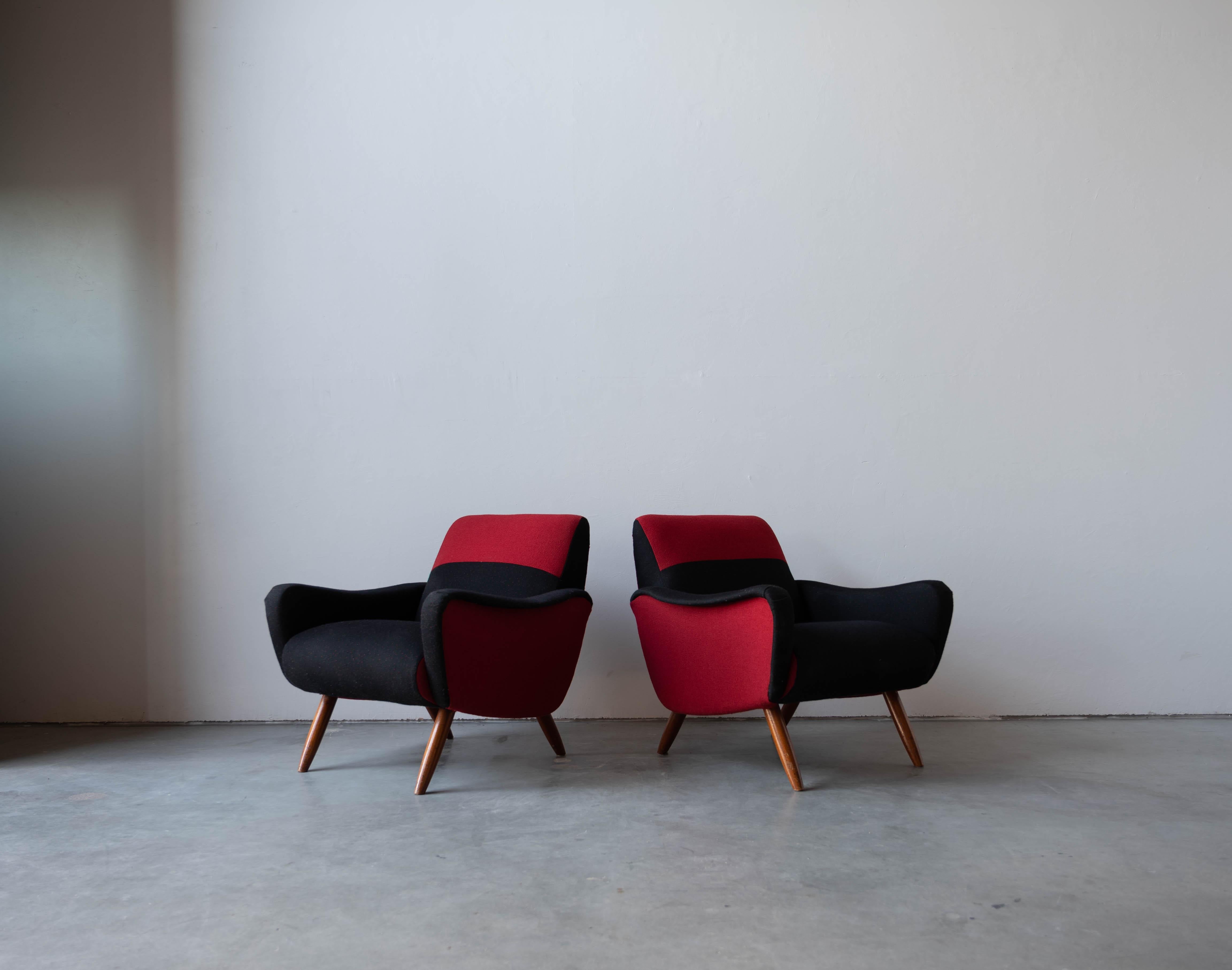 A pair of lounge chairs / armchairs, designed by Kurt Hvitsjö for Isku, Finland, 1950s.

Features an overstuffed wooden structure on finely turned wooden legs. 

Other designers of the period include Gio Ponti, Alvar Aalto, Carlo Mollino, Carlo