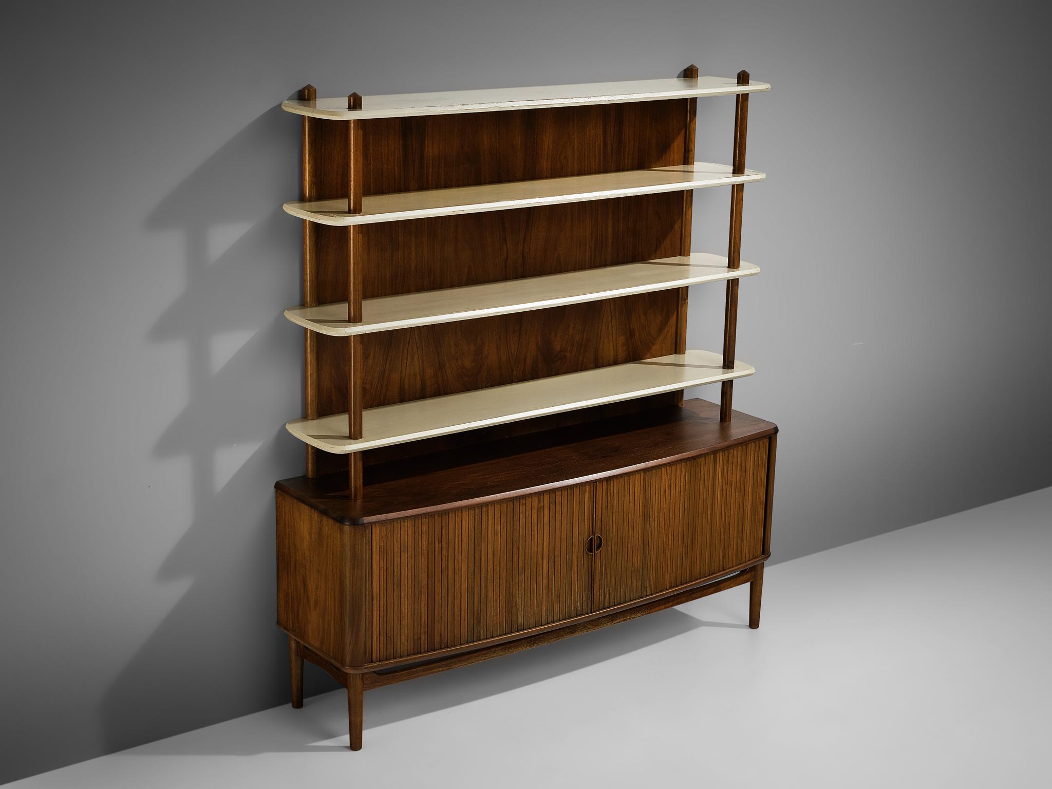 Kurt Olsen for A. Andersen & Bohm, bookcase, walnut, wood, Denmark, 1950

Kurt Olsen designed this combination of a cabinet and open shelf in 1950 for A. Andersen & Bohm. Two tambour doors access the cabinet at the bottom which is equipped with