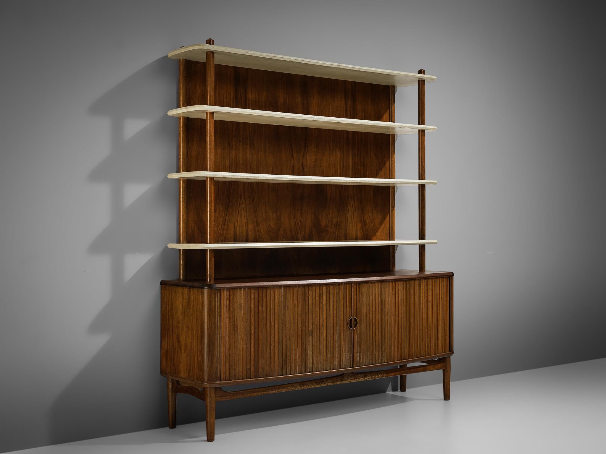Kurt Olsen for A. Andersen & Bohm, bookcase, walnut, wood, Denmark, 1950

Kurt Olsen made this combination of a cabinet and open shelf in 1950 for A. Andersen & Bohm. Two tambour doors access the cabinet at the bottom which is equipped with shelves