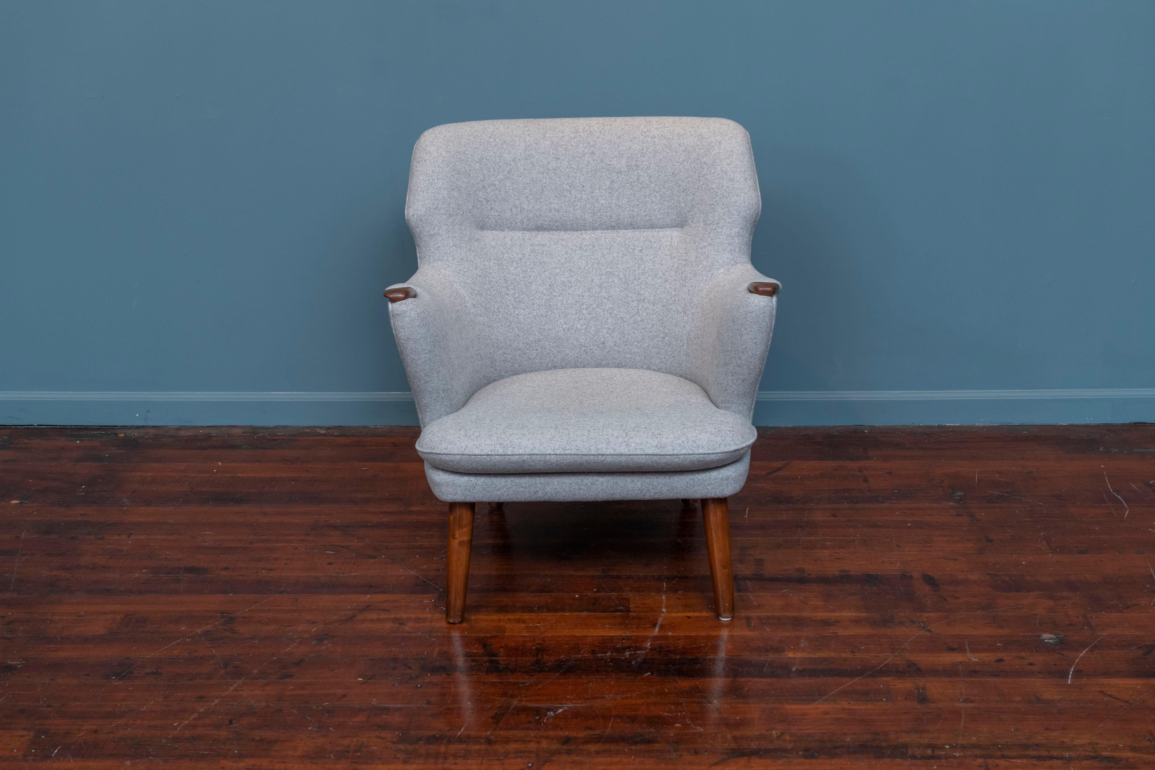 Kurt Olsen design lounge chair for Anderson & Bohm, Denmark. Newly upholstered in a light grey wool felt and refinished teak leads and arm pads. Super comfy and ready to enjoy.