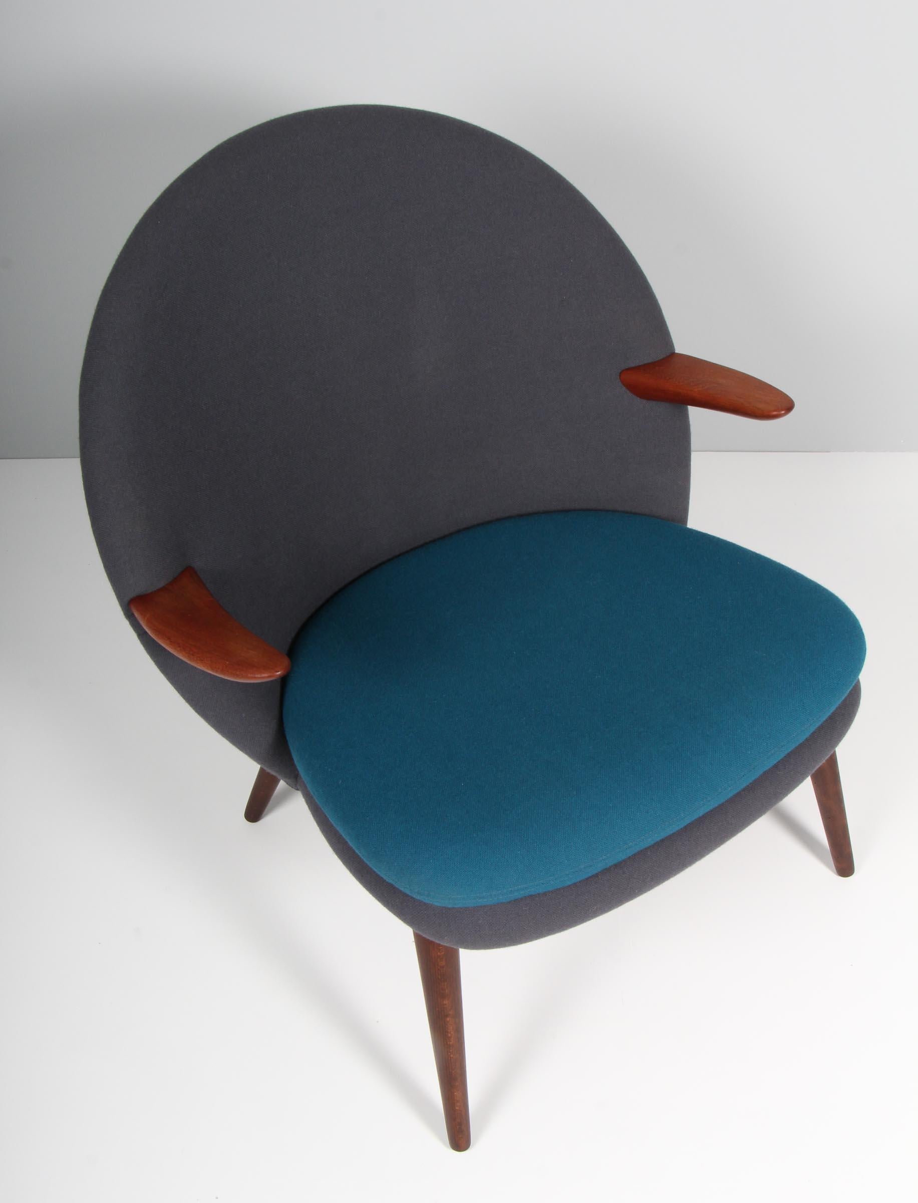 Kurt Olsen lounge chair with two colours of wool fabric. Armrests of teak. Legs of stained beech. 

Made and marked by Glostrup Møbelfabrik.