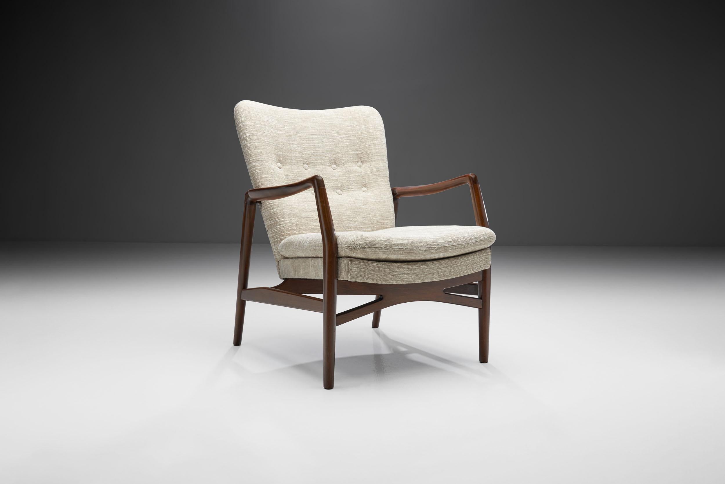 This “Model 215” easy chair was designed by Danish designer and architect Kurt Olsen, and unifies some of the best characteristics of mid-century Danish design and craftsmanship.

The unique design of this chair is in big part thanks to Olsen’s