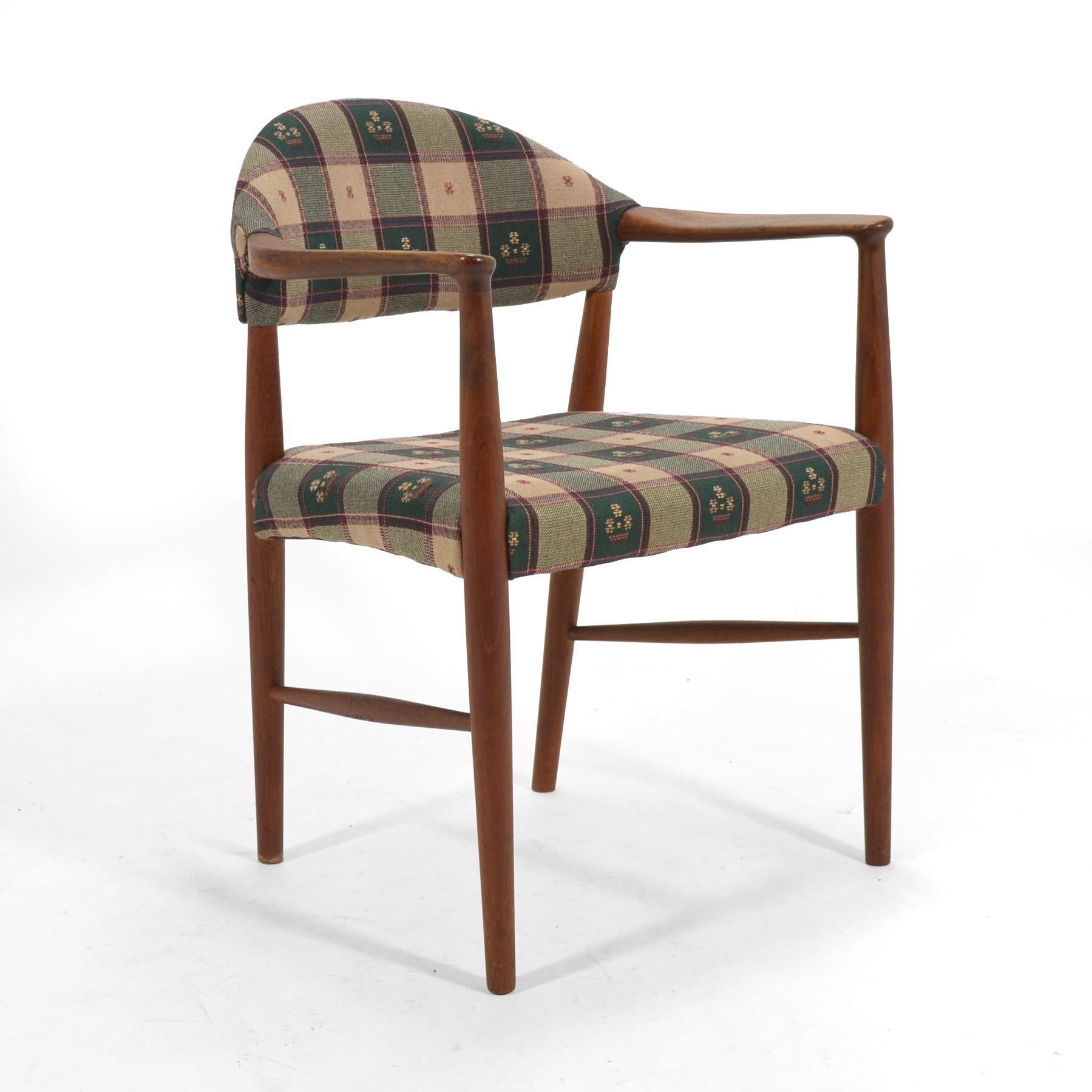 Designed by Kurt Olsen for Slagelse Møbelværk in 1955, this model 223 armchair is an understated, timeless design. Crafted of teak, it retains its original hand-loomed fabric upholstery, but would also look spectacular redone in the fabric or