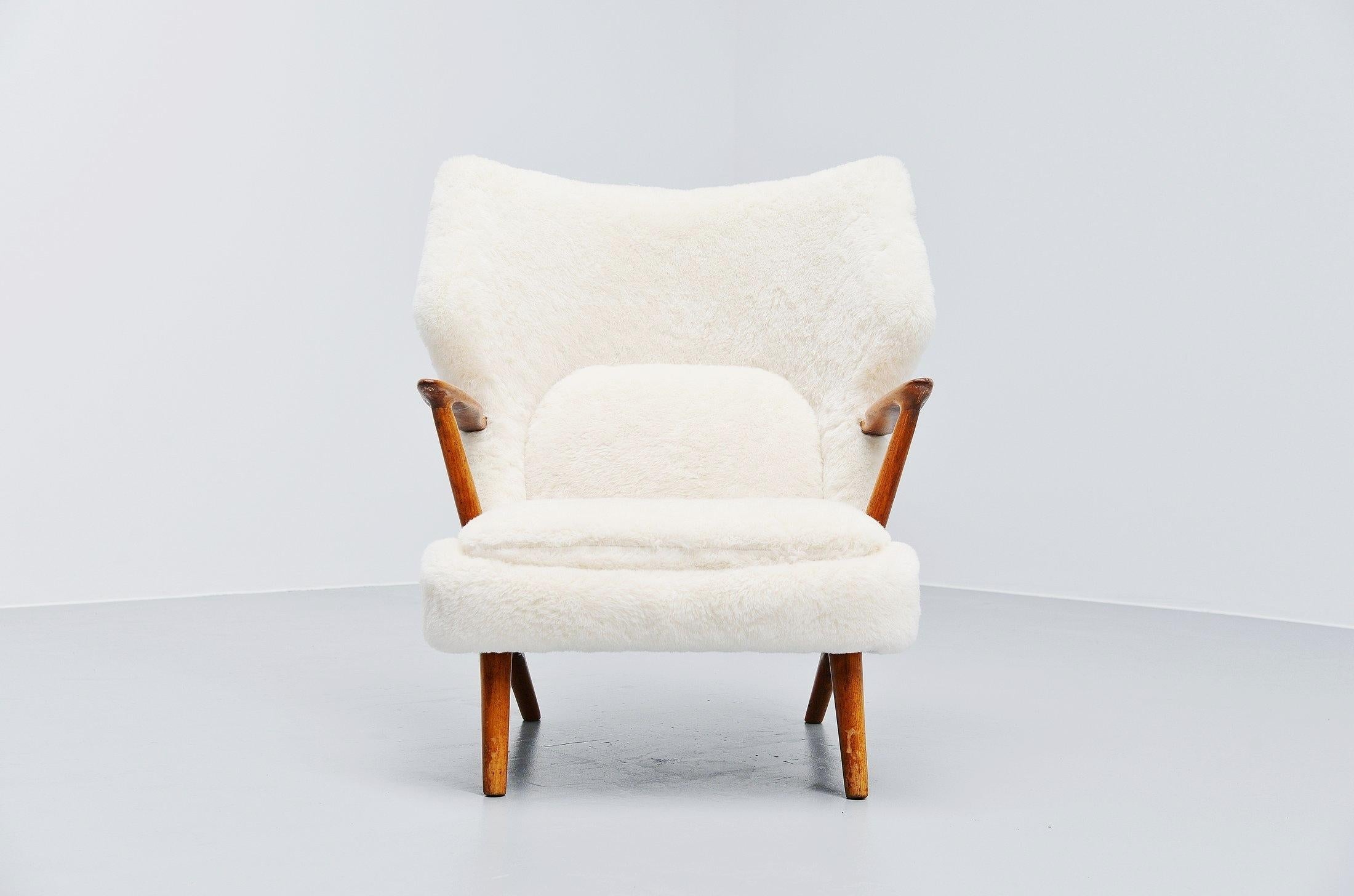 Stunning large lounge chair model 221 designed by Kurt Olsen and manufactured by Slagelse Møbelvaerk, Denmark, 1955. This chair has a solid teak frame and is newly upholstered in high quality teddy fabric made from Alpaca wool. The chair seats very