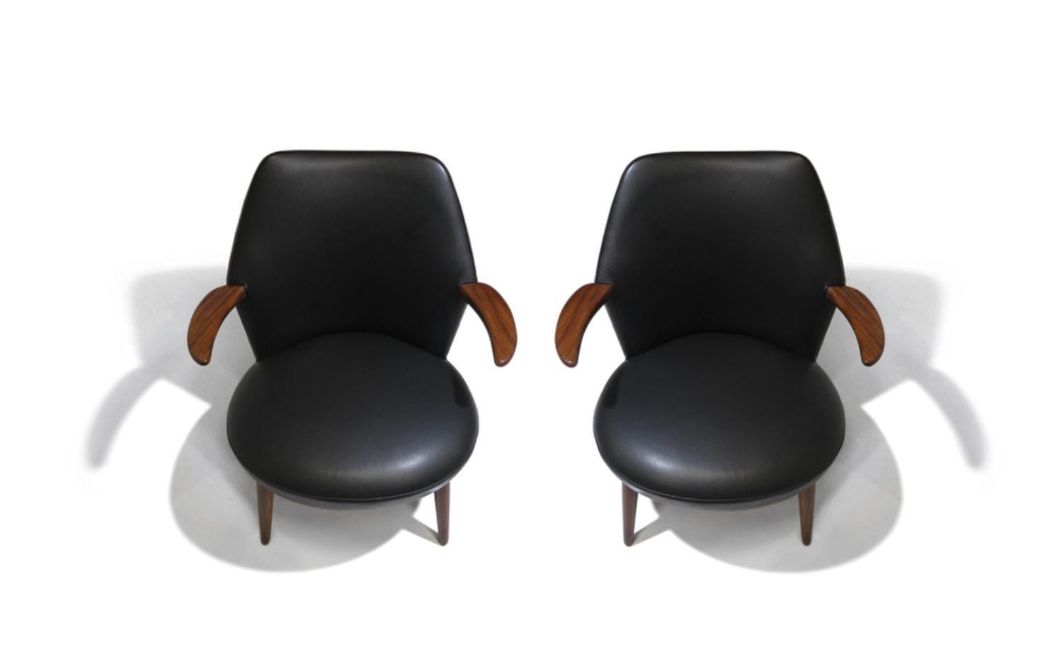 Mid-century danish lounge chairs with curved backs and horn-shaped arms raised on tapered teak legs, newly upholstered in black leather. Chairs are in excellent condition with minor signs of age and use.
Measurements
W 29.13’’ x D 29.25’’ x