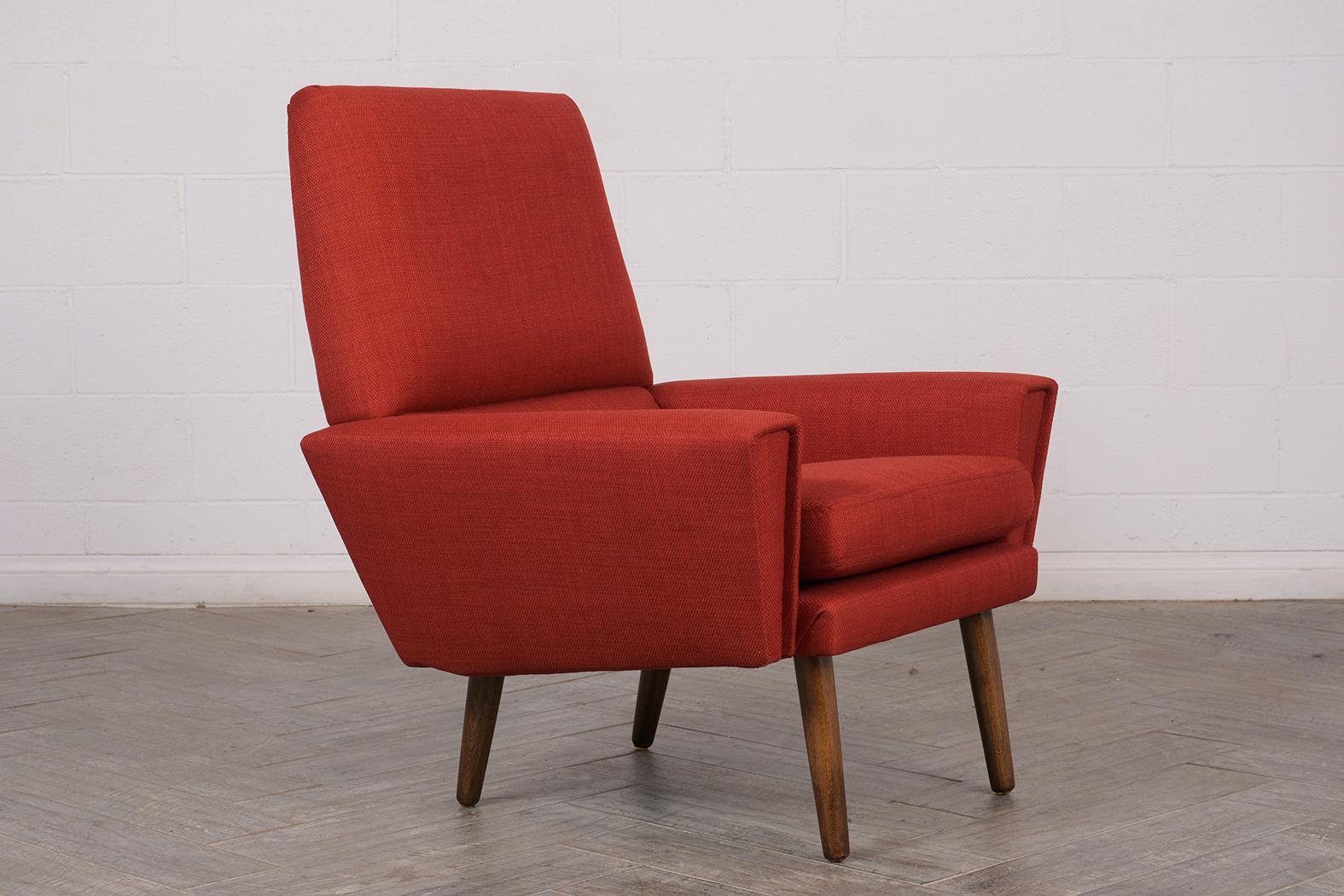 Experience the charm of Danish design with our fully restored Kurt Ostervig Danish-style lounge chair. Upholstered in a vibrant new red fabric by our expert team of craftsmen, this chair exudes a modern aesthetic. The chair is designed for comfort,