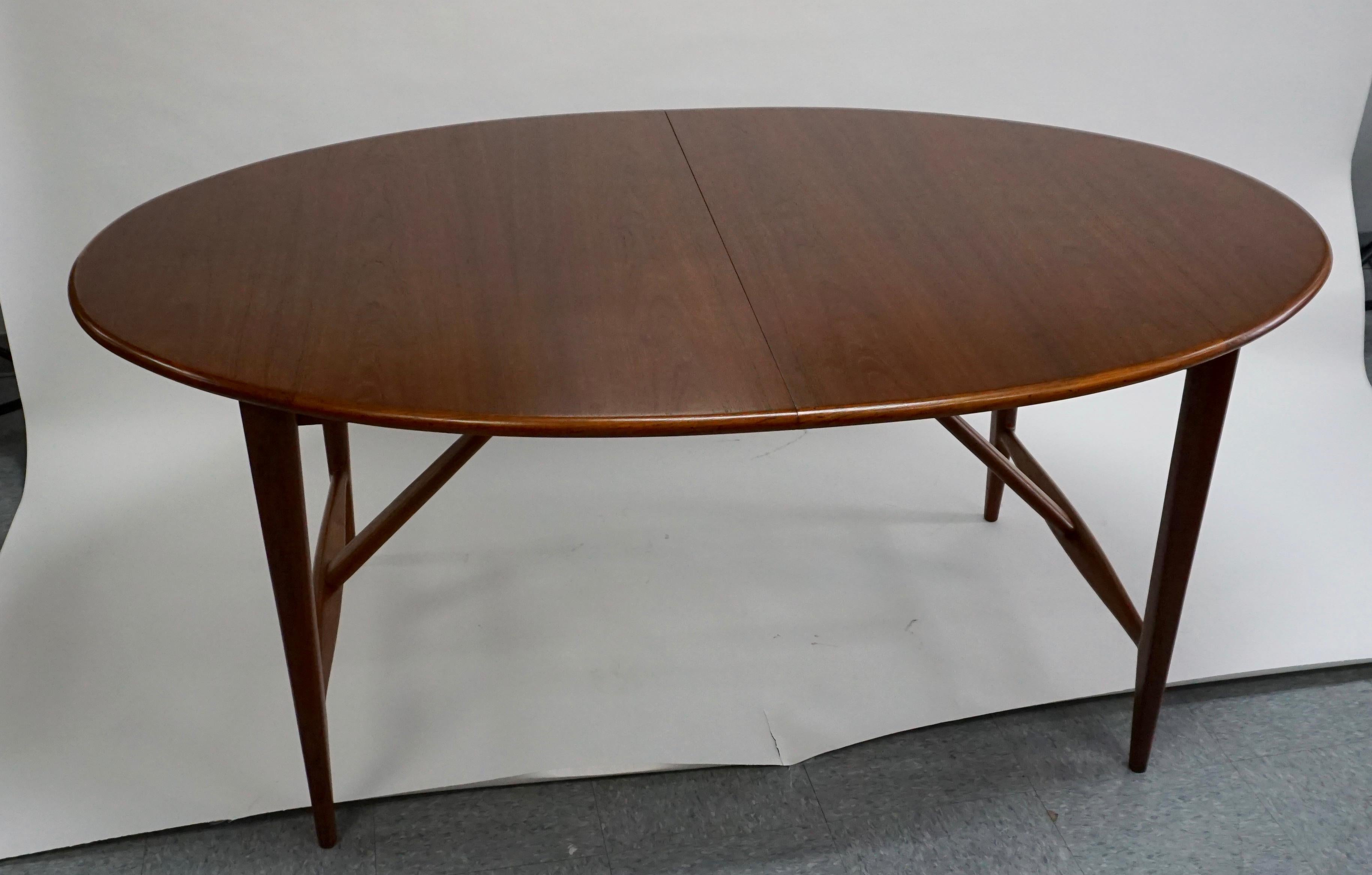 Restored. This long oval table is 120 inches long when all 3 of the 18 inch leaves are in place. Scales down to just 66 inches long without any leaves. Only 42 inches wide at centre, making this a great table for more narrow spaces. Teak is a