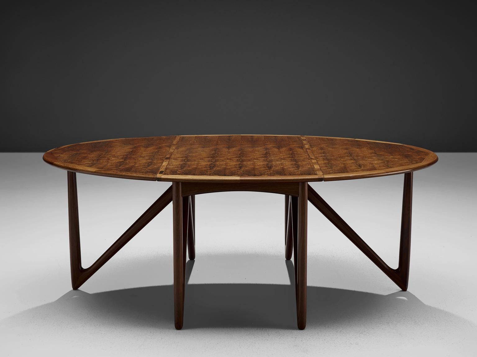 Kurt Ostervig for Jason Mobler Danish modern, oval table in rosewood, Denmark 1960s.

This rare drop-leaf table shows an unusual, impressive base of six V-shaped legs, made with extraordinary craftsmanship. The clear shape of the oval top nicely