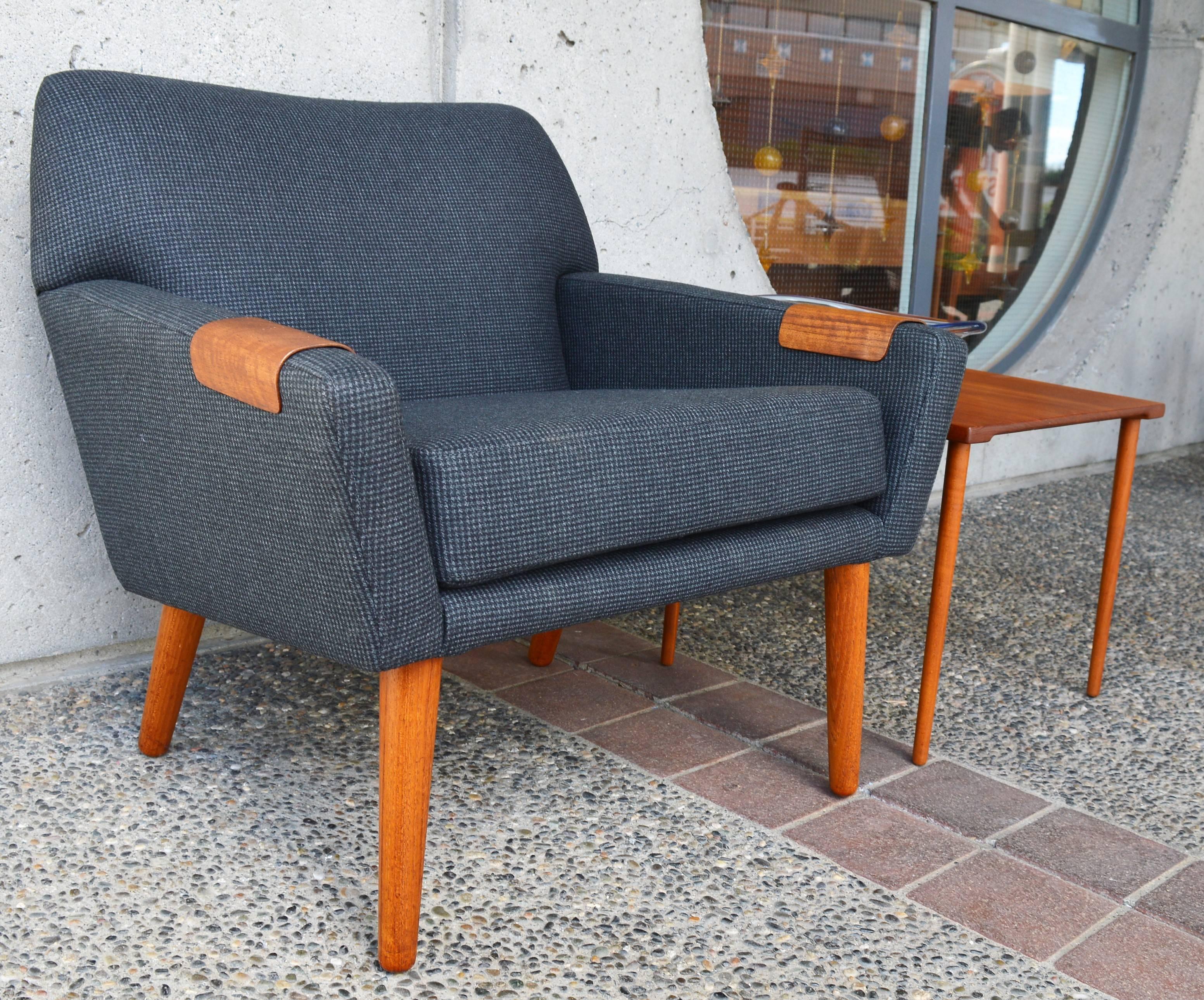 This spectacular Danish modern rare teak tub chair was designed by Kurt Ostervig for Rolschau in the 1950s. A great compact, slightly more upright lounge chair that has been completely restored, stripped to the wood frame, frame repairs are done