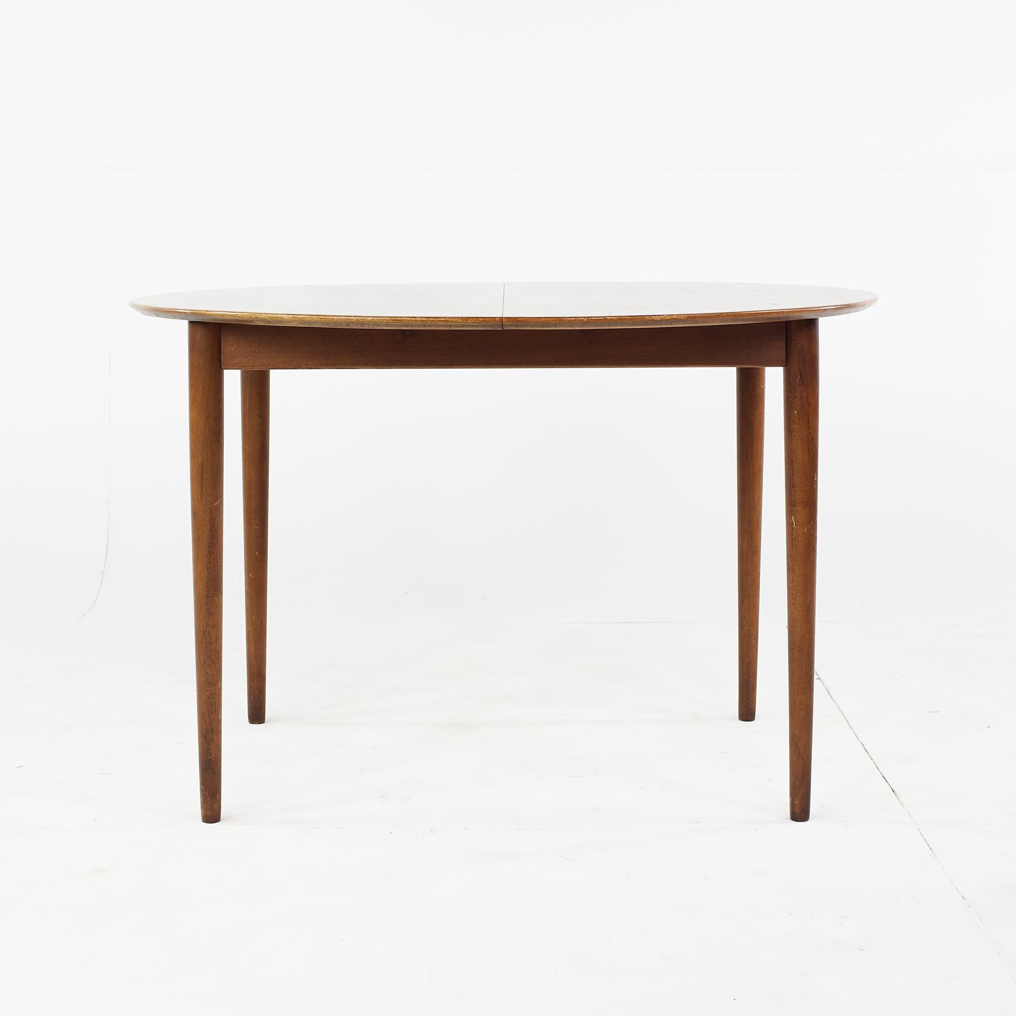 Kurt Ostervig mid century teak expanding round dining table

This dining table measures: 45.25 wide x 45.25 deep x 29 inches high, with chair clearance of 25.5 inches, the leaf measures 23.75 inches wide, making the maximum width of the table 69