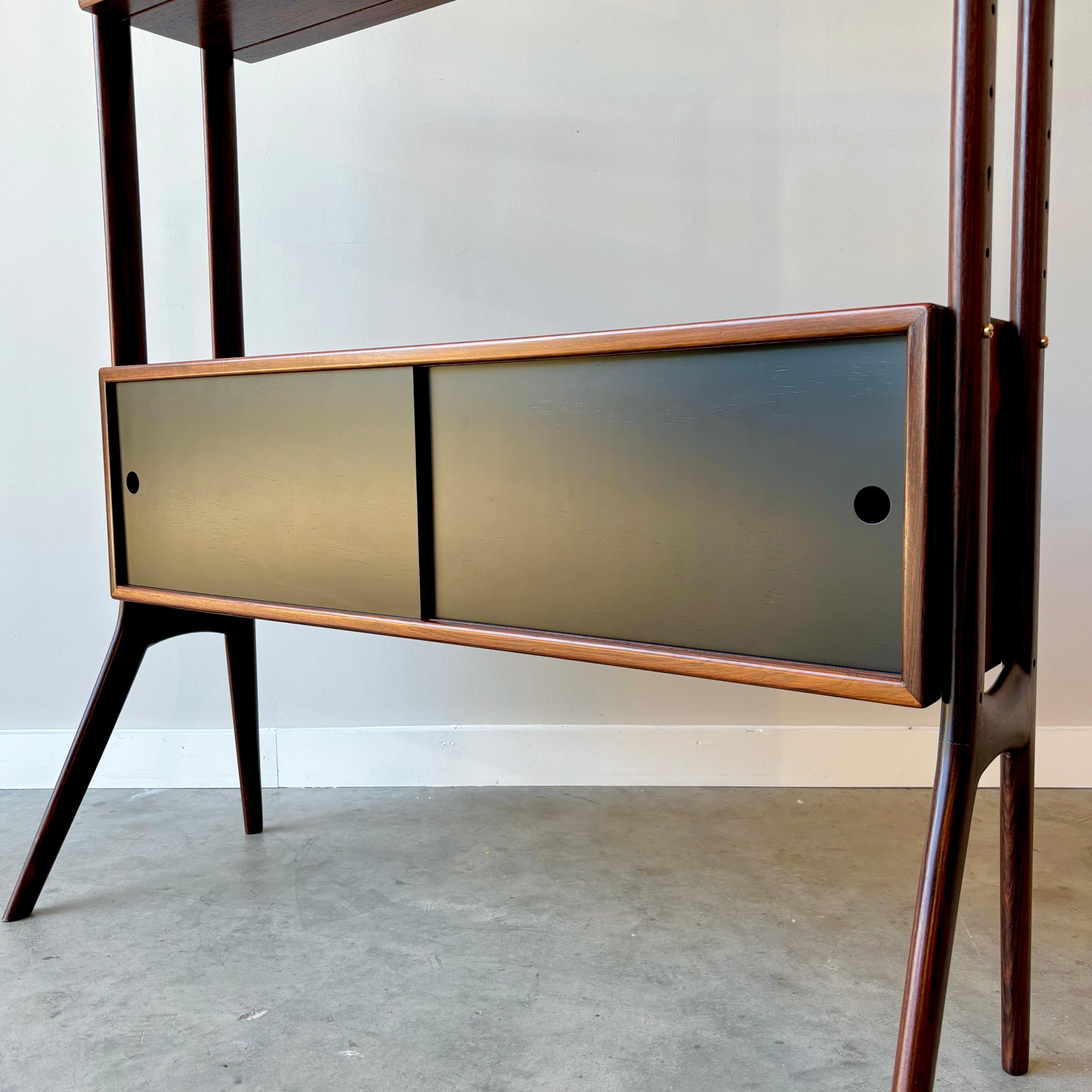 Ein moderner Klassiker aus der Mitte des Jahrhunderts.  Mit seinem schön geformten Rahmen und den Messingbeschlägen kann dieses Stück in jedem Interieur platziert werden.  Professionell restauriert mit maßgefertigten Schiebetüren, die die Glasfront