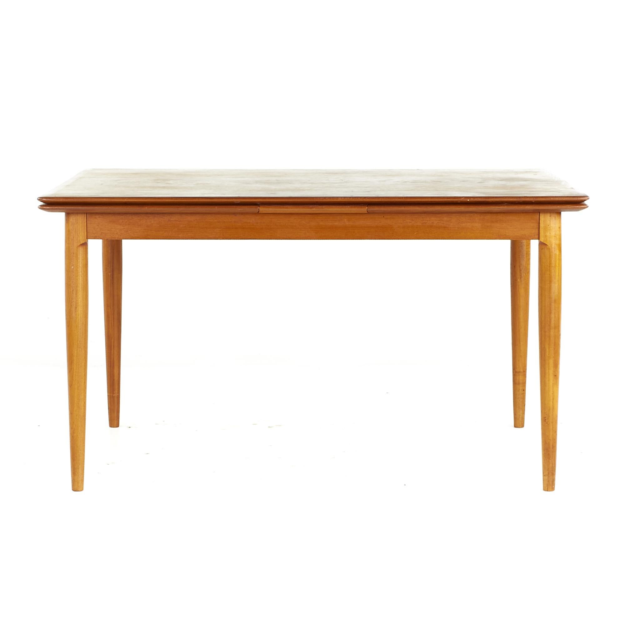 Kurt Ostervig Style Mid Century Teak Dining Room Table with Hidden Leaves

This table measures: 51.25 wide x 37.25 deep x 28.25 high, with a chair clearance of 24 inches, each leaf measures 20.5 inches wide, making a maximum table width of 92.25