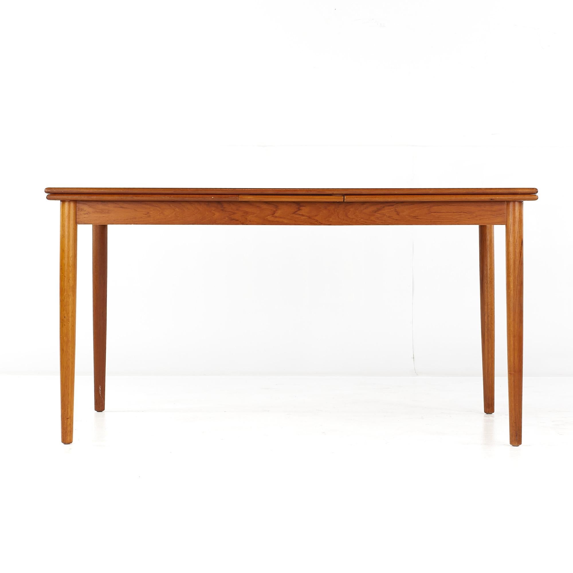 Kurt Ostervig Style Mid Century Teak Hidden Leaf Dining Table

This table measures: 55.25 wide x 34.25 deep x 29.5 high, with a chair clearance of 25 inches
(The extended measurements for this table are pending)

All pieces of furniture can be had